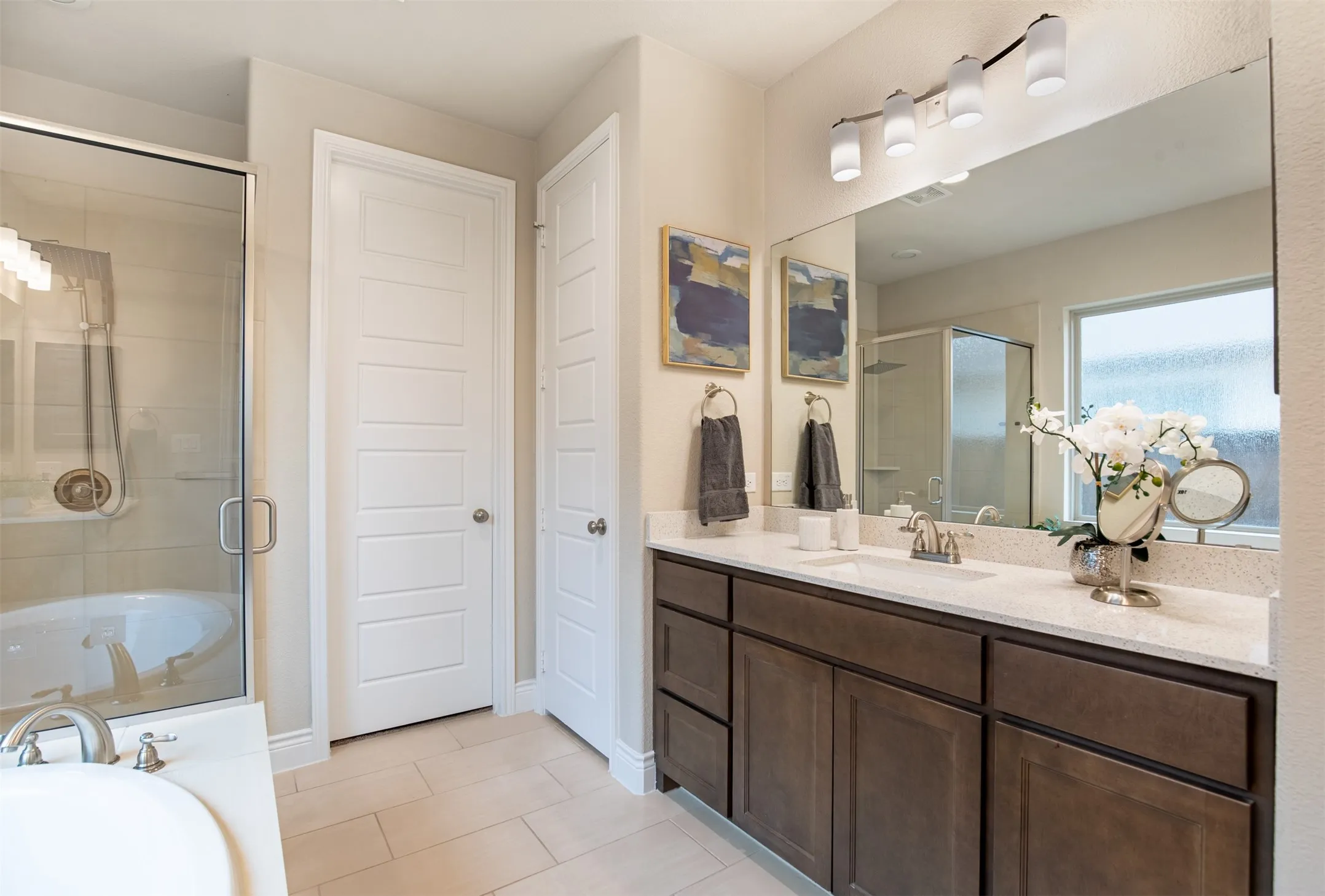 Dual vanity with undermount sinks and light-colored countertops