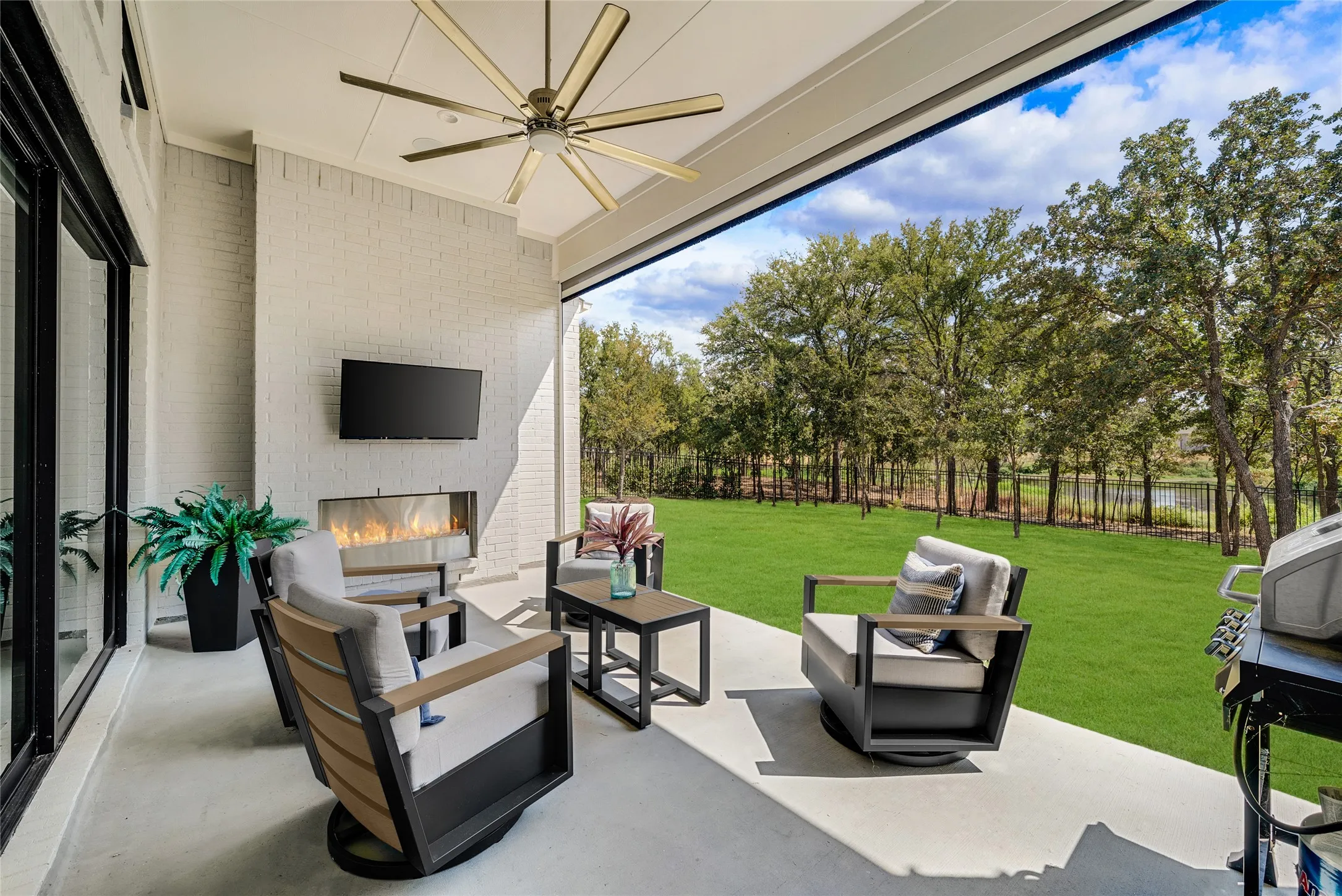 This private and tranquil outdoor living space has a cozy fireplace and motorized screen so your patio can be enjoyed all year round