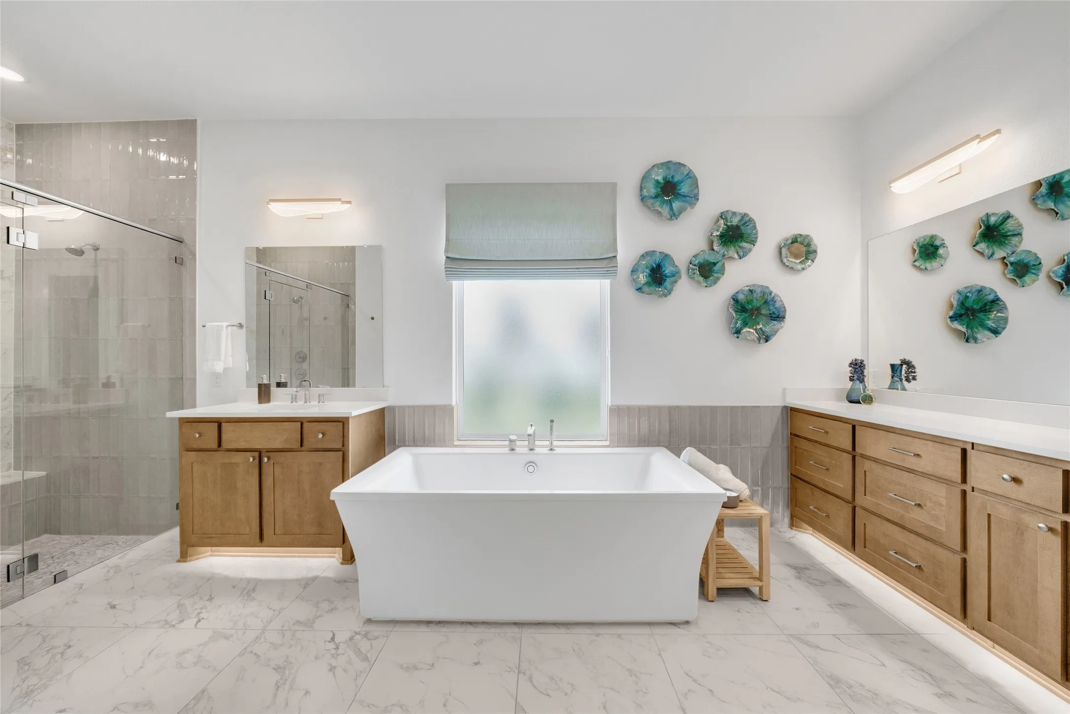 Luxury Primary Bath that is separated with his and closets from the primarybedroom