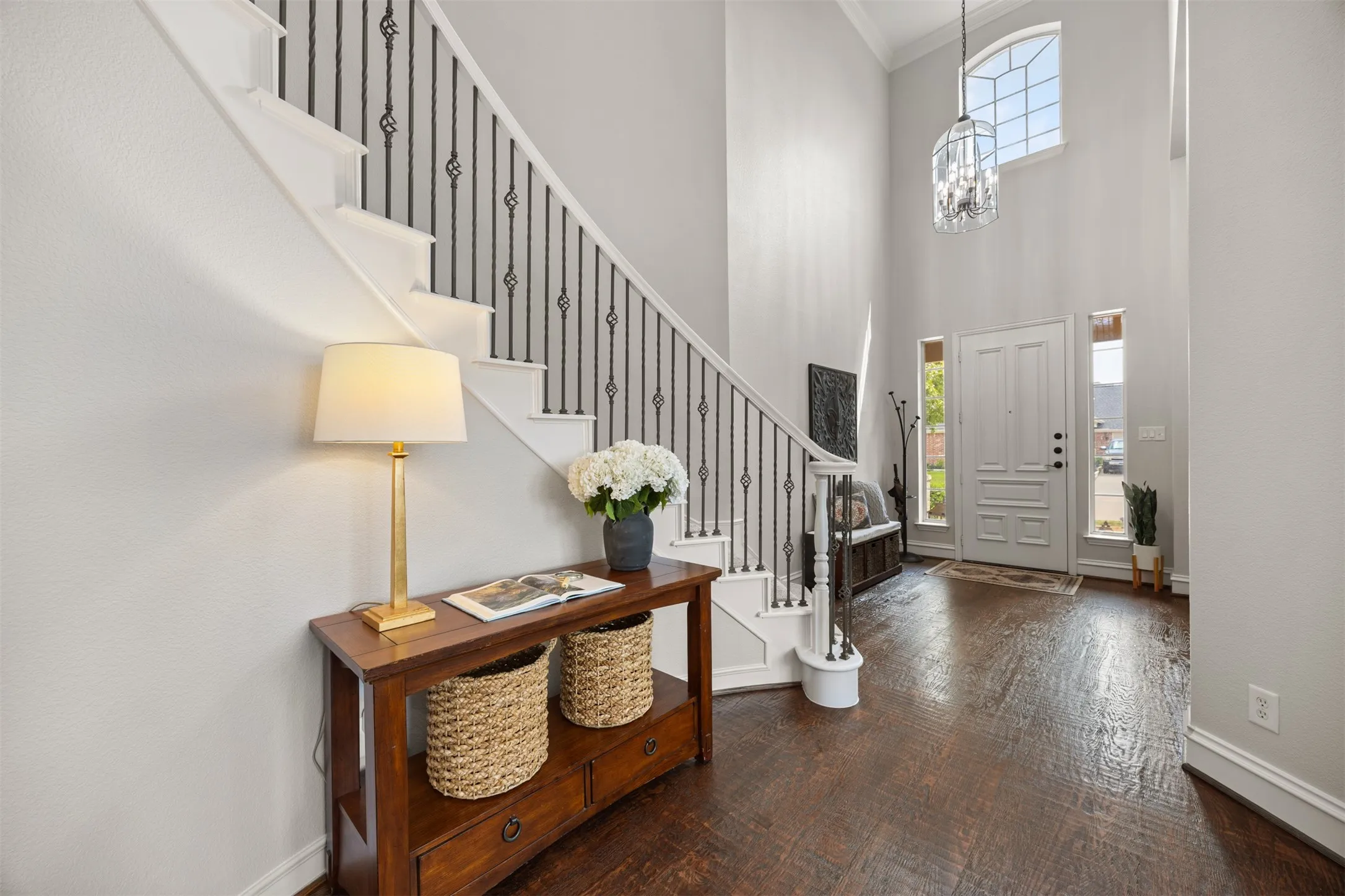 Step inside where a grand curved staircase creates a beautiful first impression! Wow!