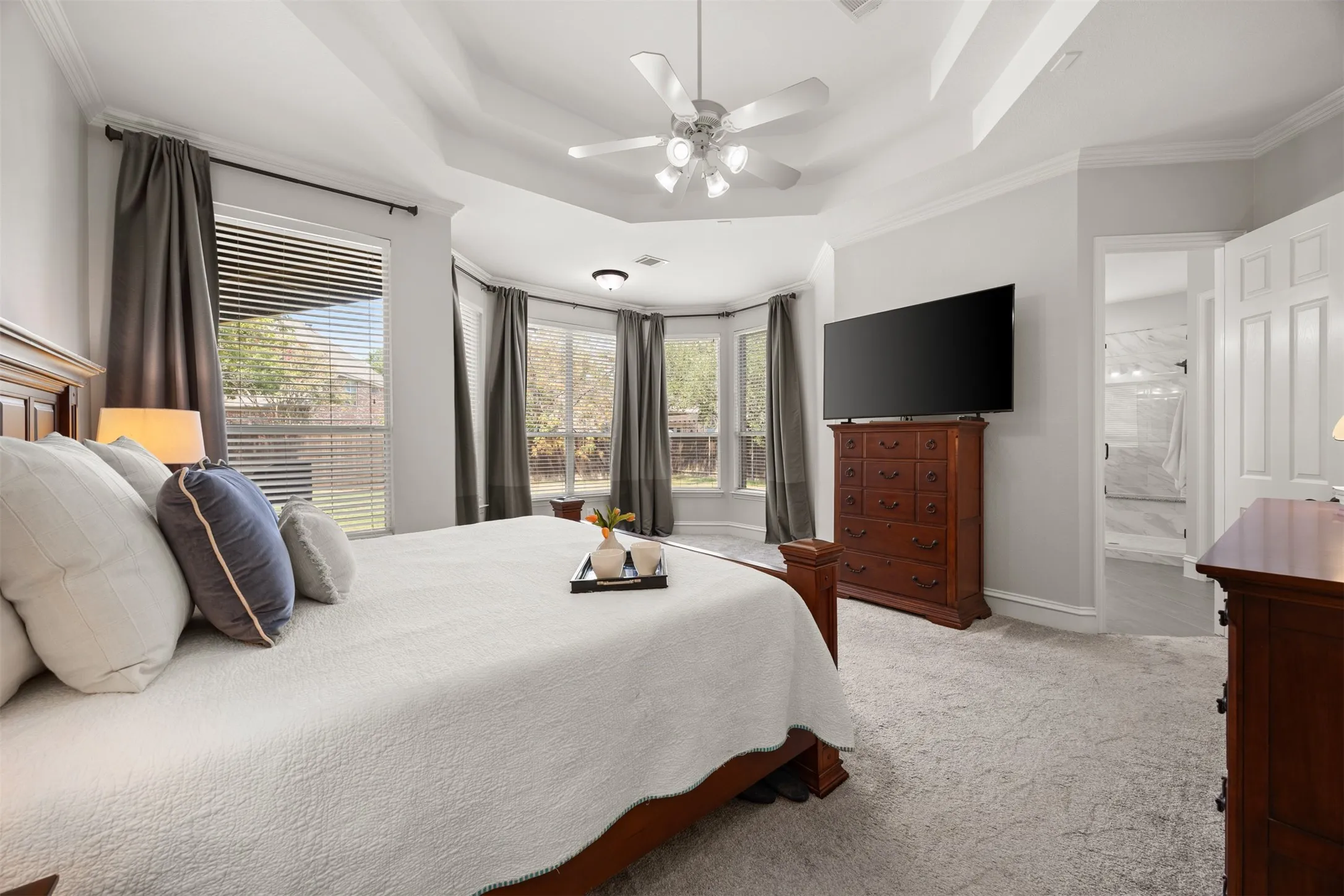 Escape at the end of the day to the serene main suite overlooking the enormous backyard. Look at all that natural light!
