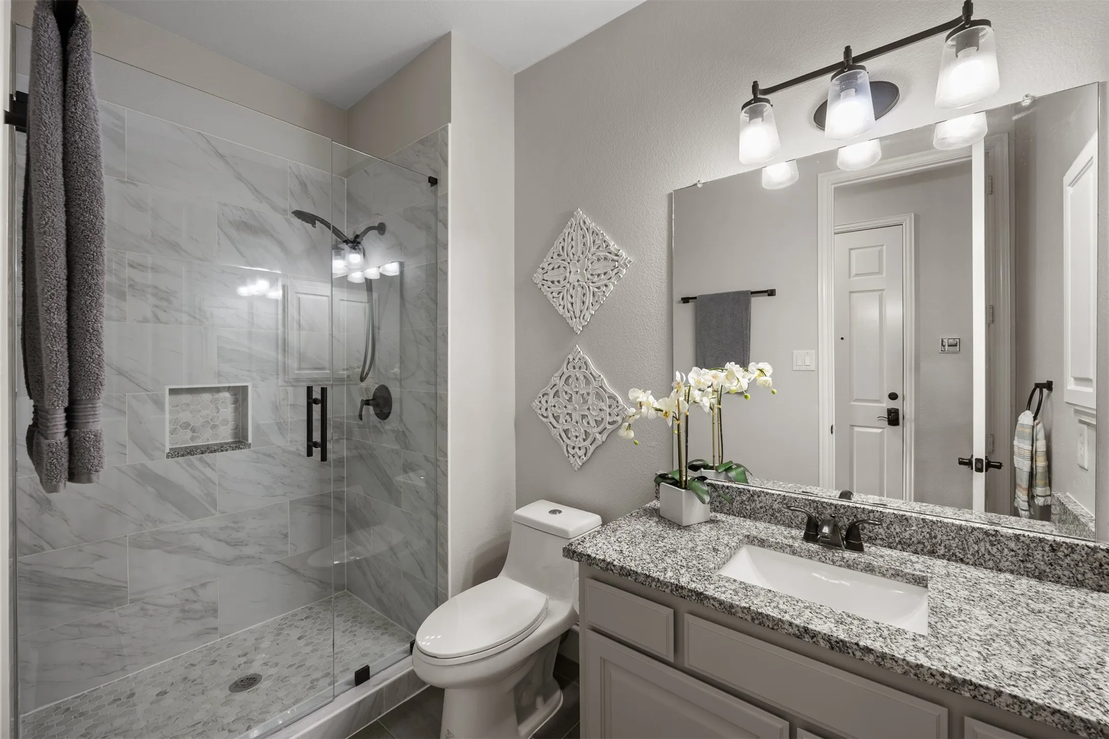 Beautifully remodeled downstairs bath with a frameless shower! So lovely!