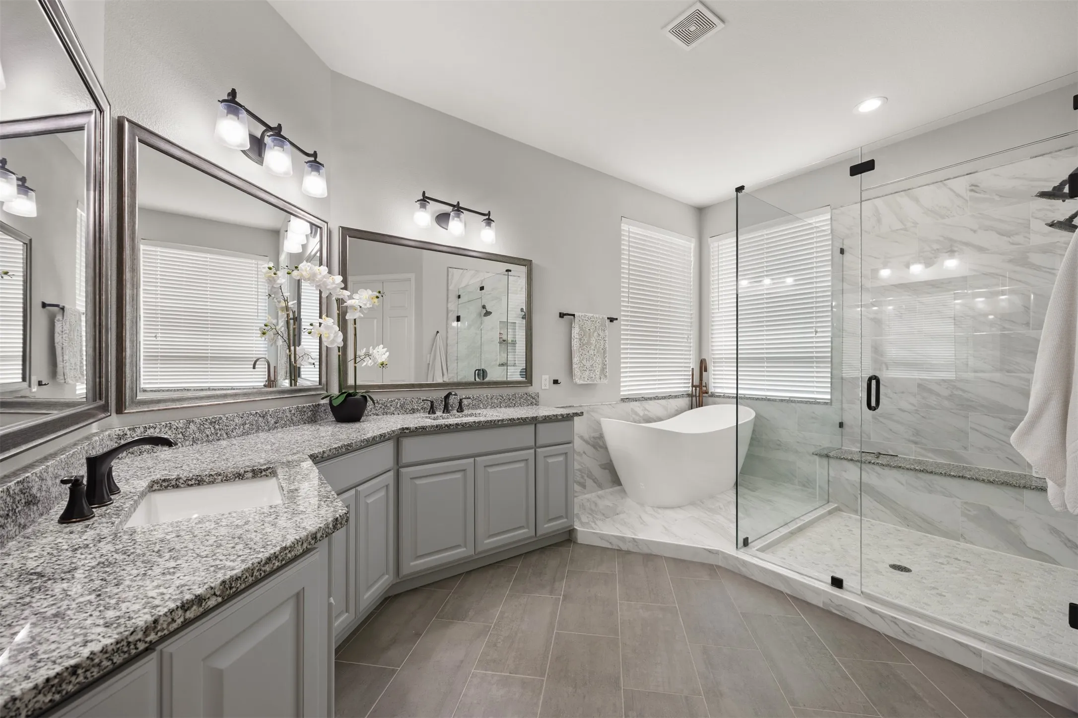 Completely remodeled ensuite bath feels luxurious & relaxing with gorgeous finishes, a freestanding tub, frameless shower & a large walk-in closet. So gorgeous!