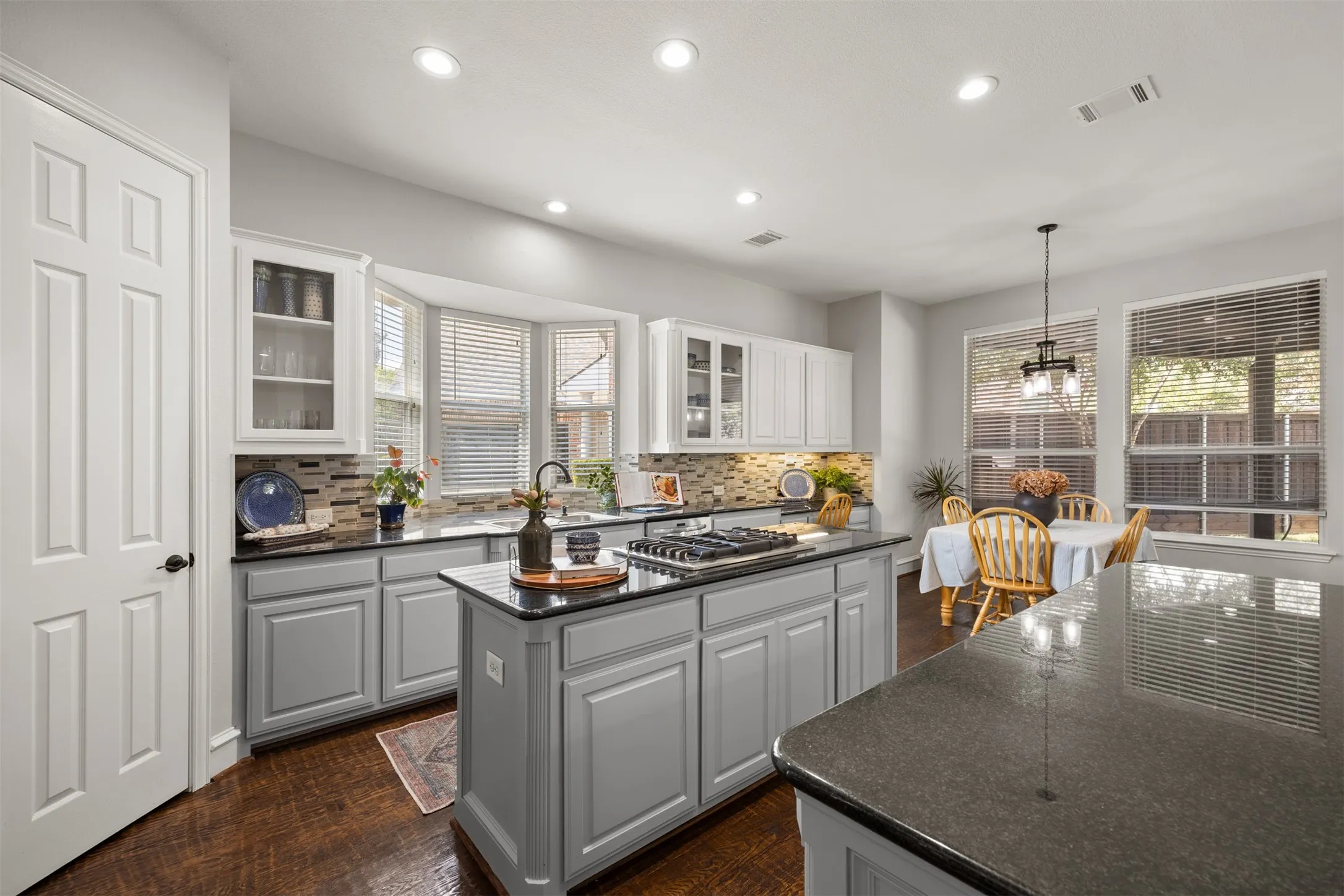At the heart of the home is an inviting chef’s kitchen where meals, laughter & memories are meant to be shared. Custom details, stylish granite & a designer tile backsplash!