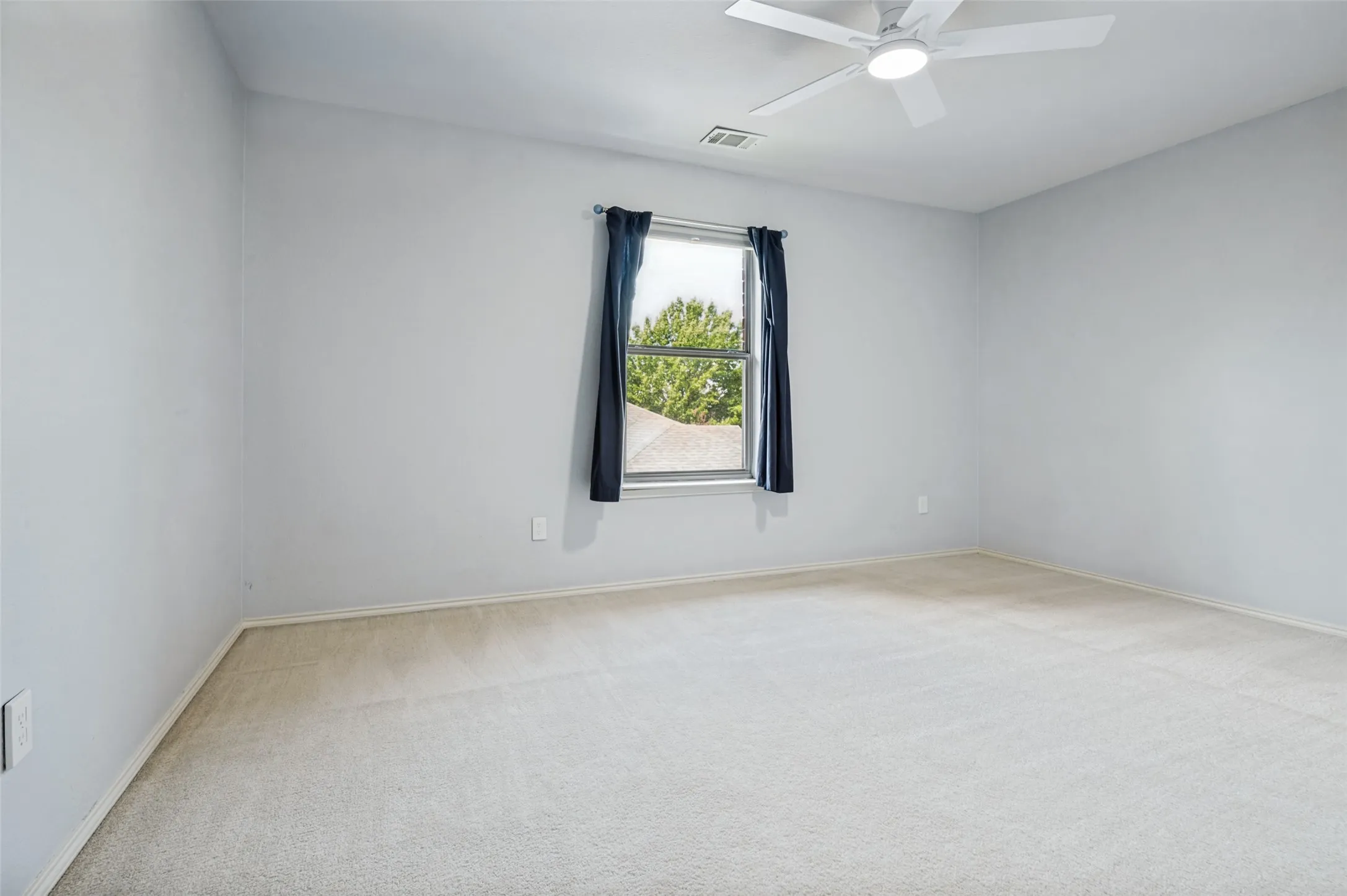 Window with operable blinds, wall-to-wall carpeting, and a ceiling fan with integrated lighting