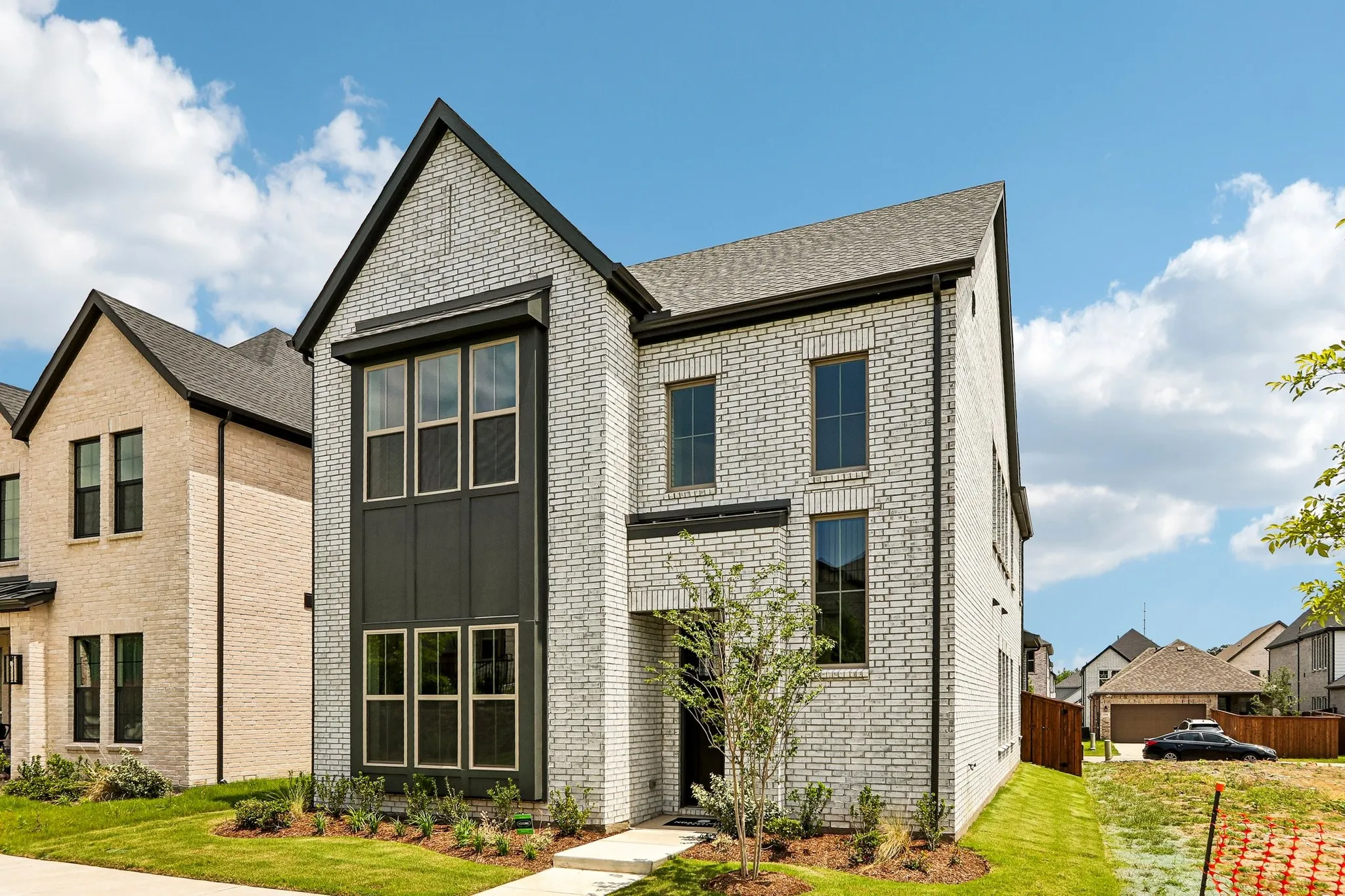 Featuring beautiful white brick with striking dark trim, this dream home offers outstanding curb appeal!