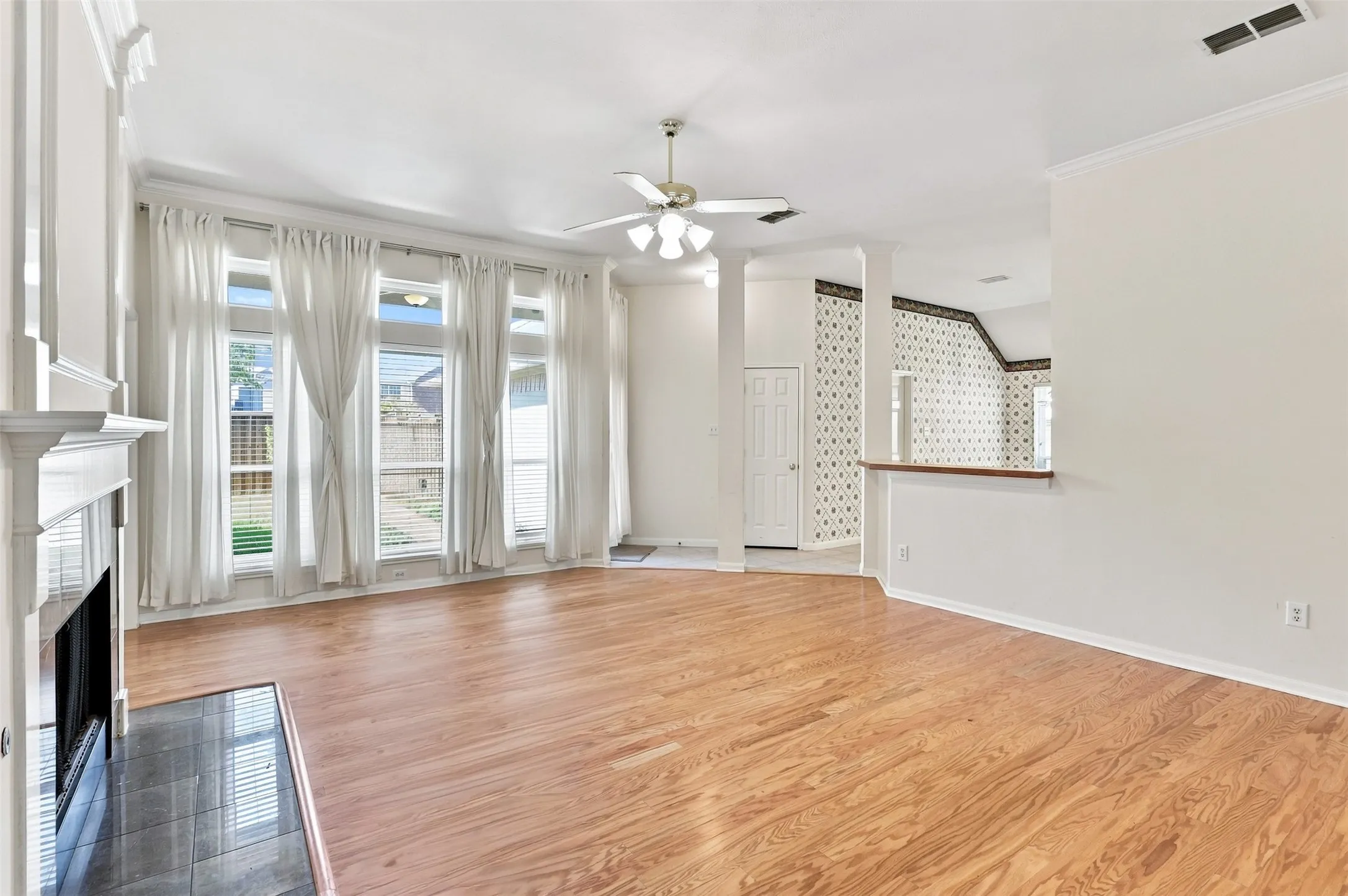 Wall of windows in living room look to backyard and allow for lots of natural light.