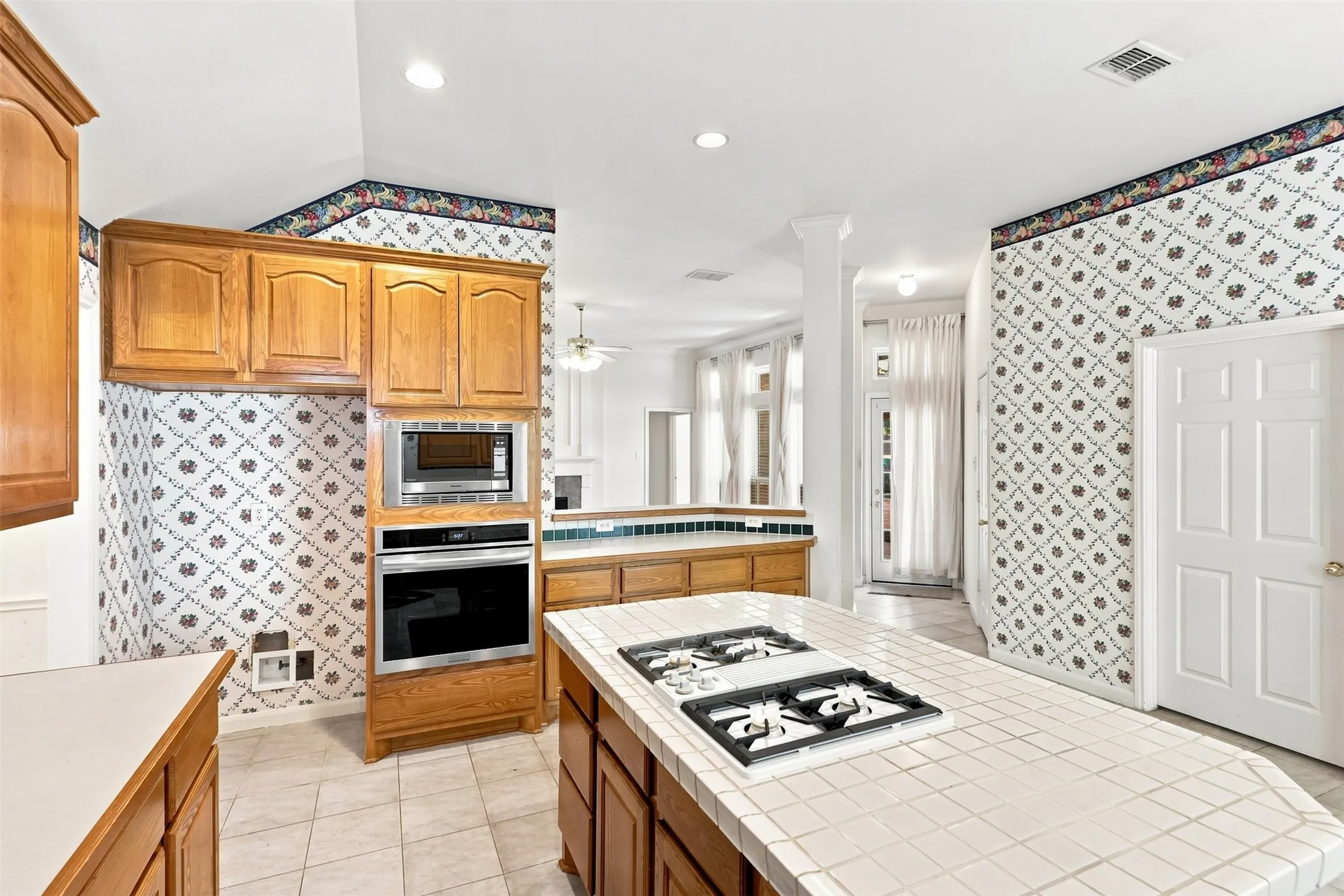 Kitchen featuring a built-in oven, built-in microwave, and wood cabinetry.