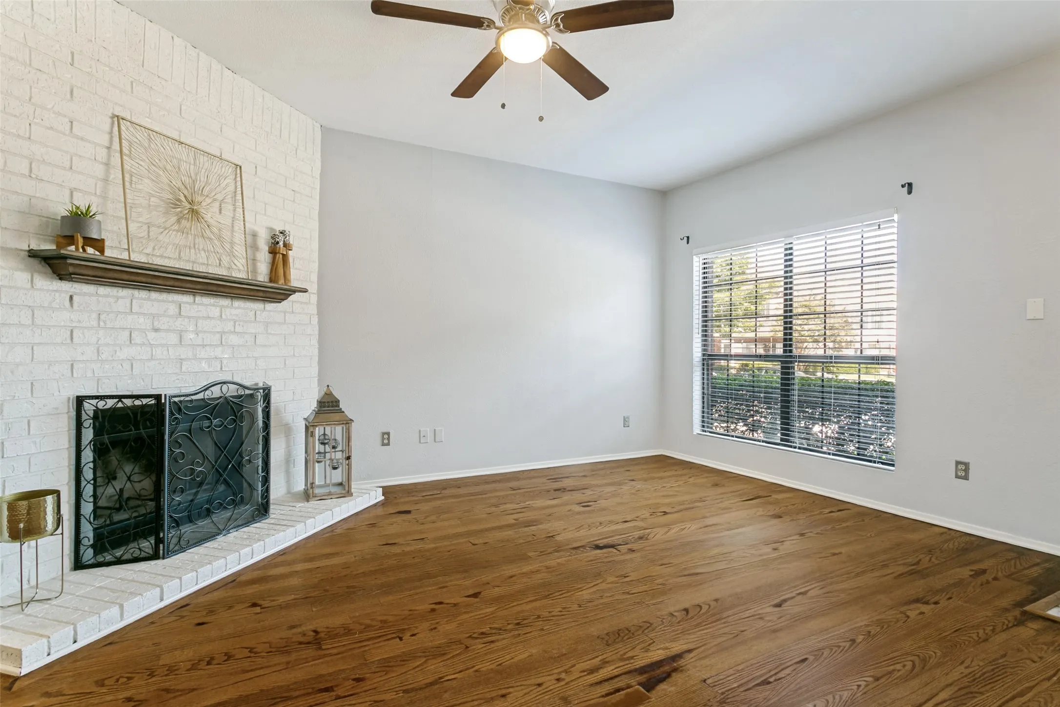 Spacious living area with hardwood floors and cozy fireplace