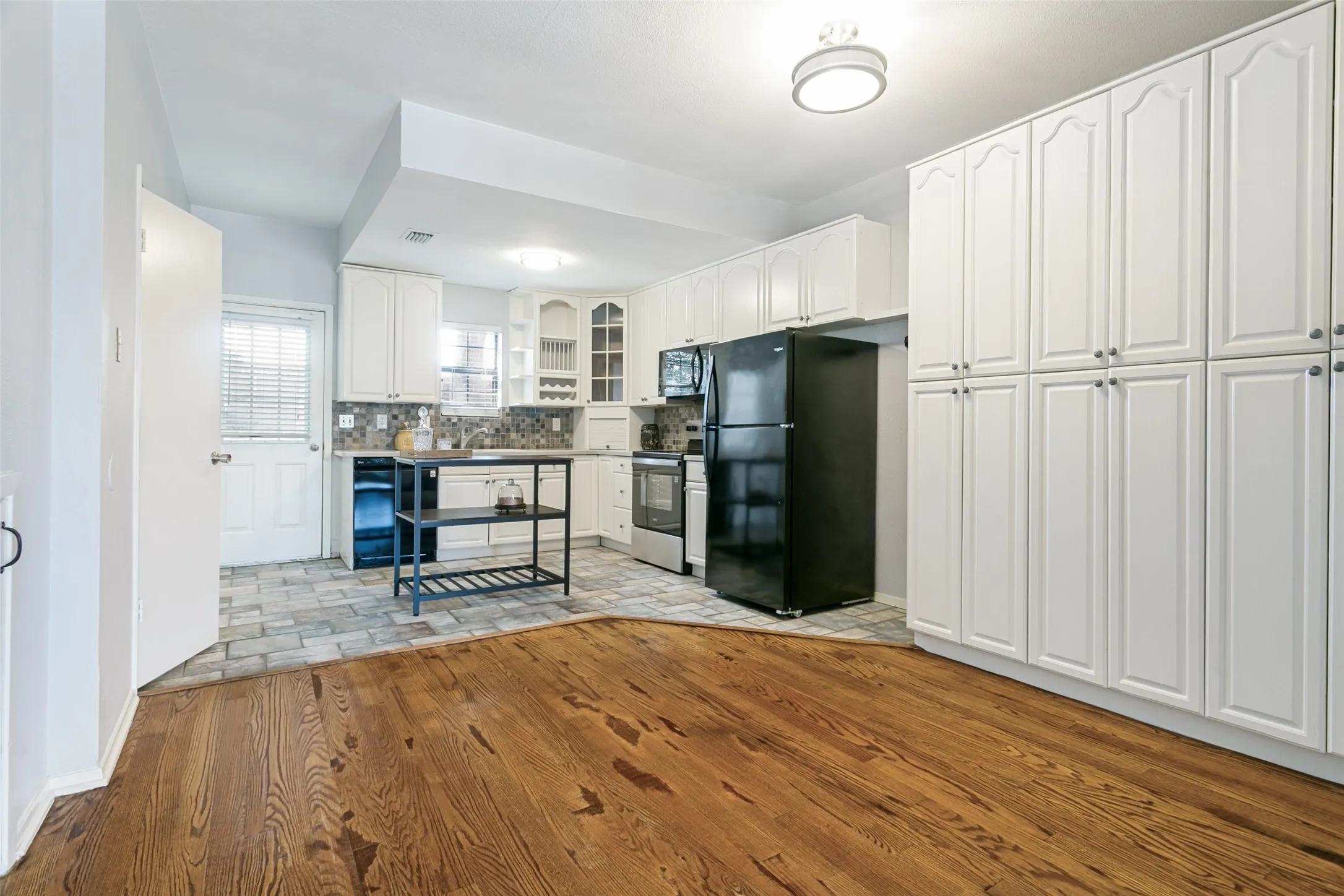 open to kitchen with floor to ceiling storage