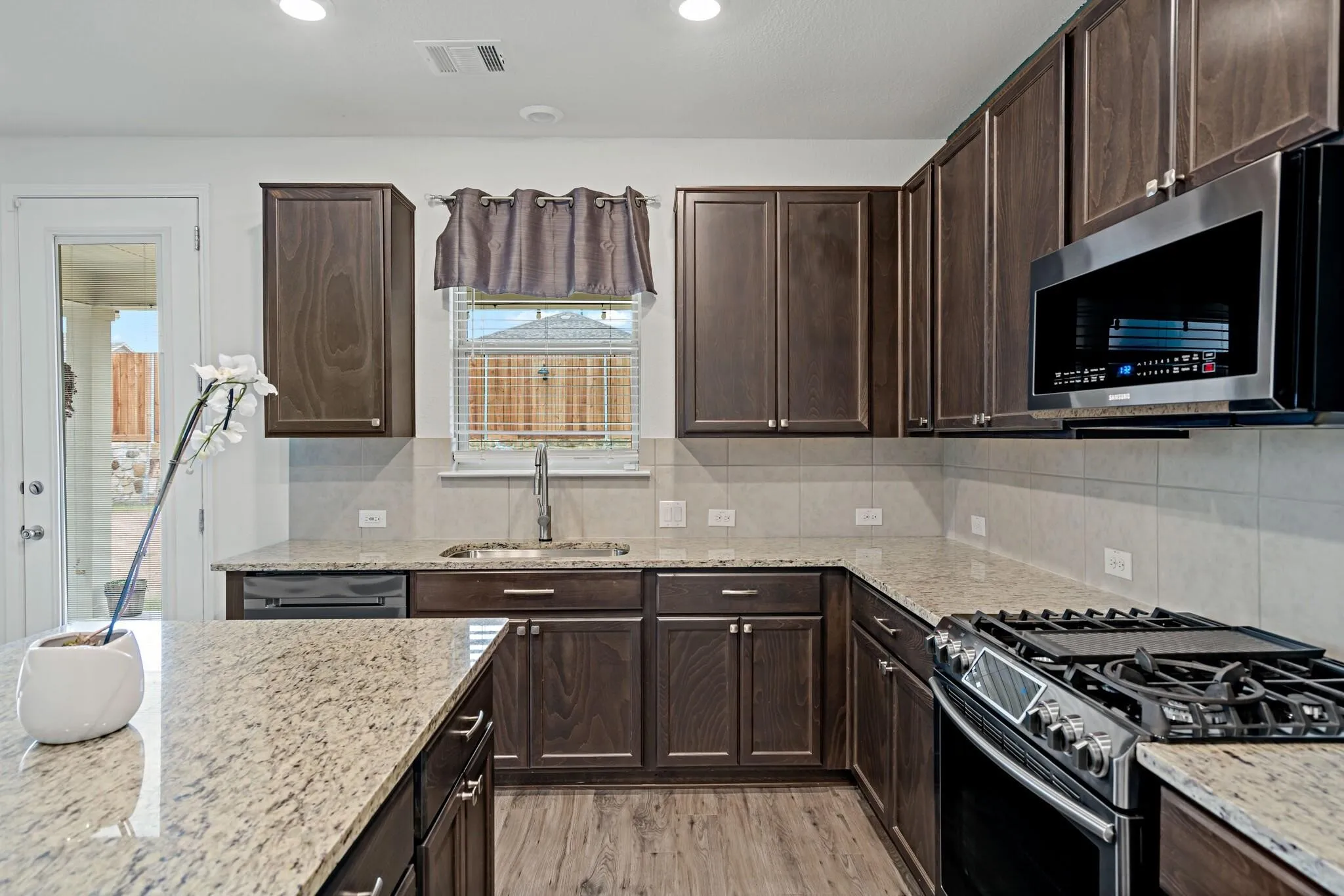 Primary bathroom with granite countertops and oversized shower.