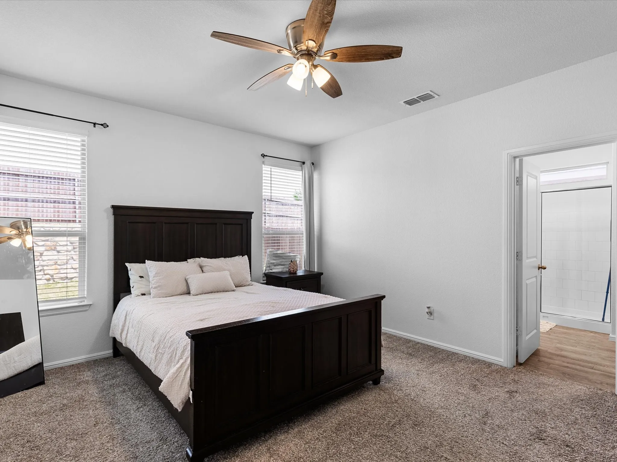 Carpeted flooring throughout, recessed lighting, ceiling fan, and white walls