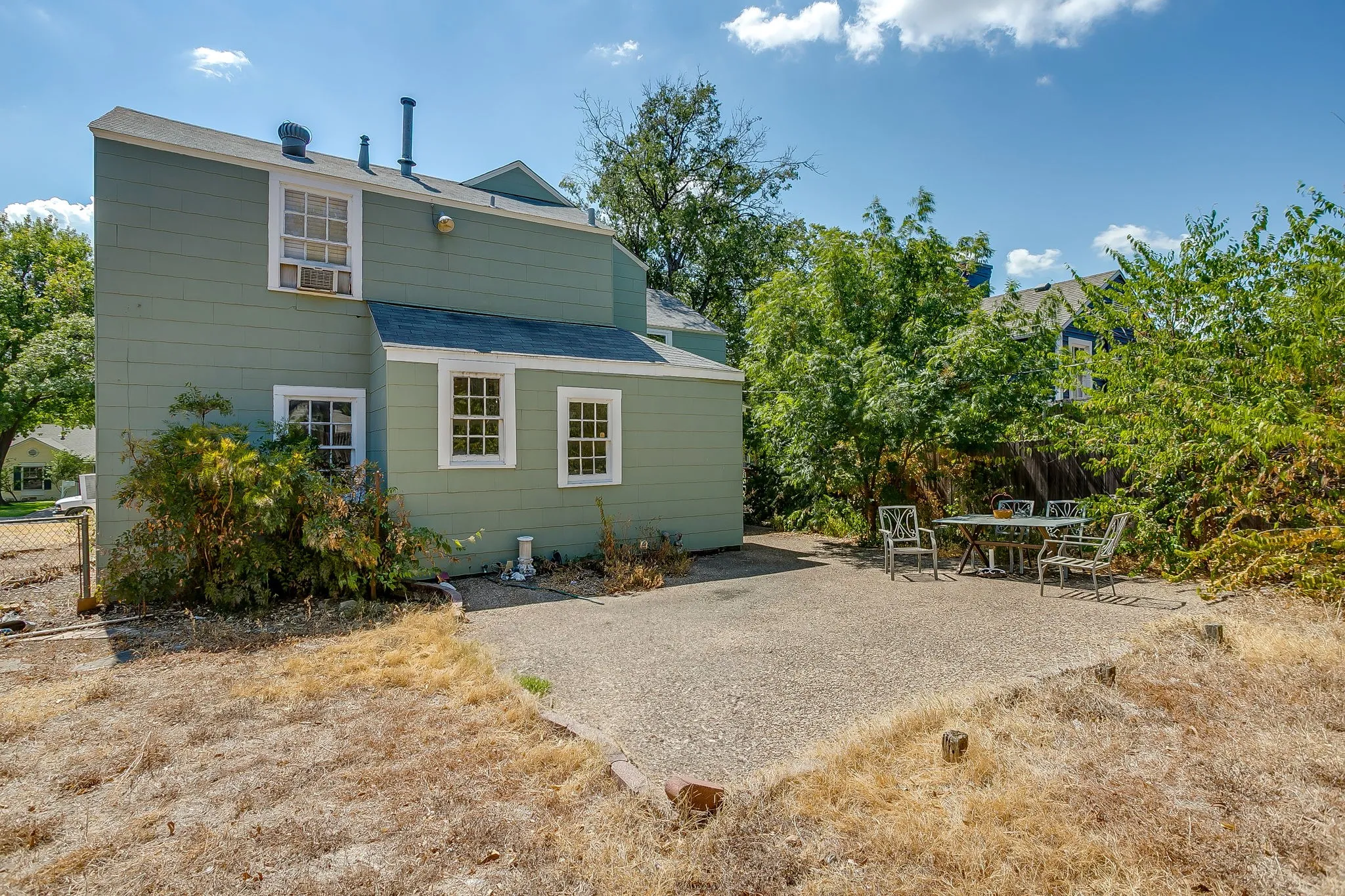 Back of home with concrete patio view
