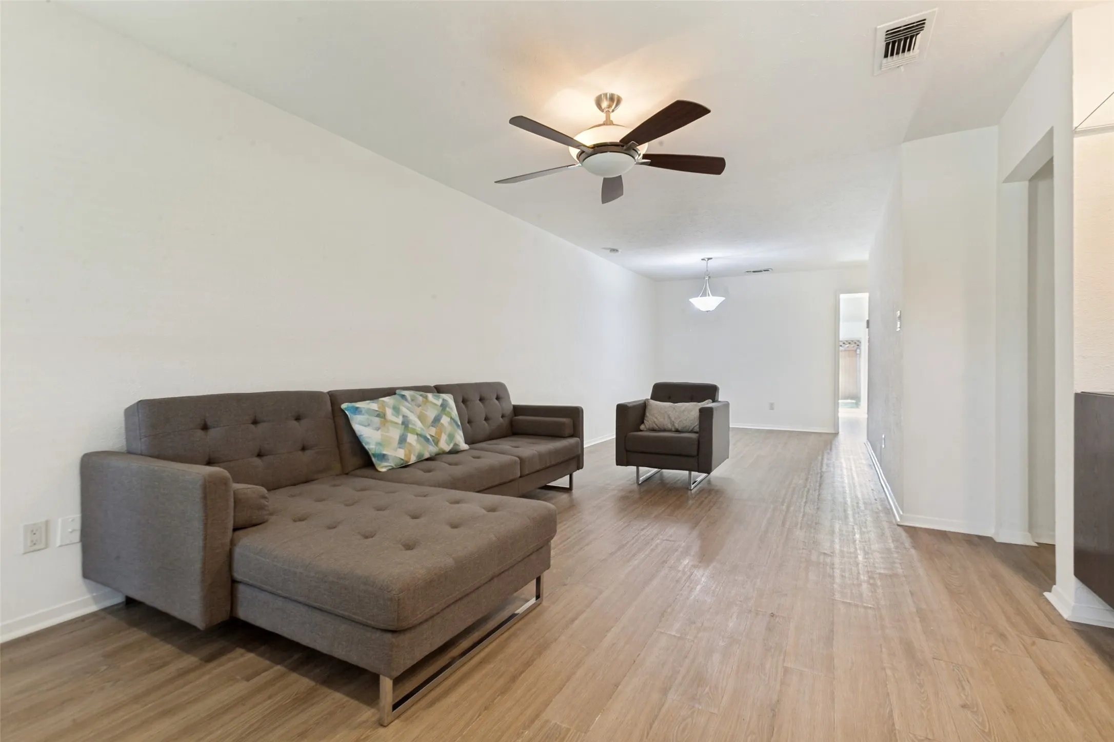 Recessed lighting, ceiling fan, and wood-finish flooring