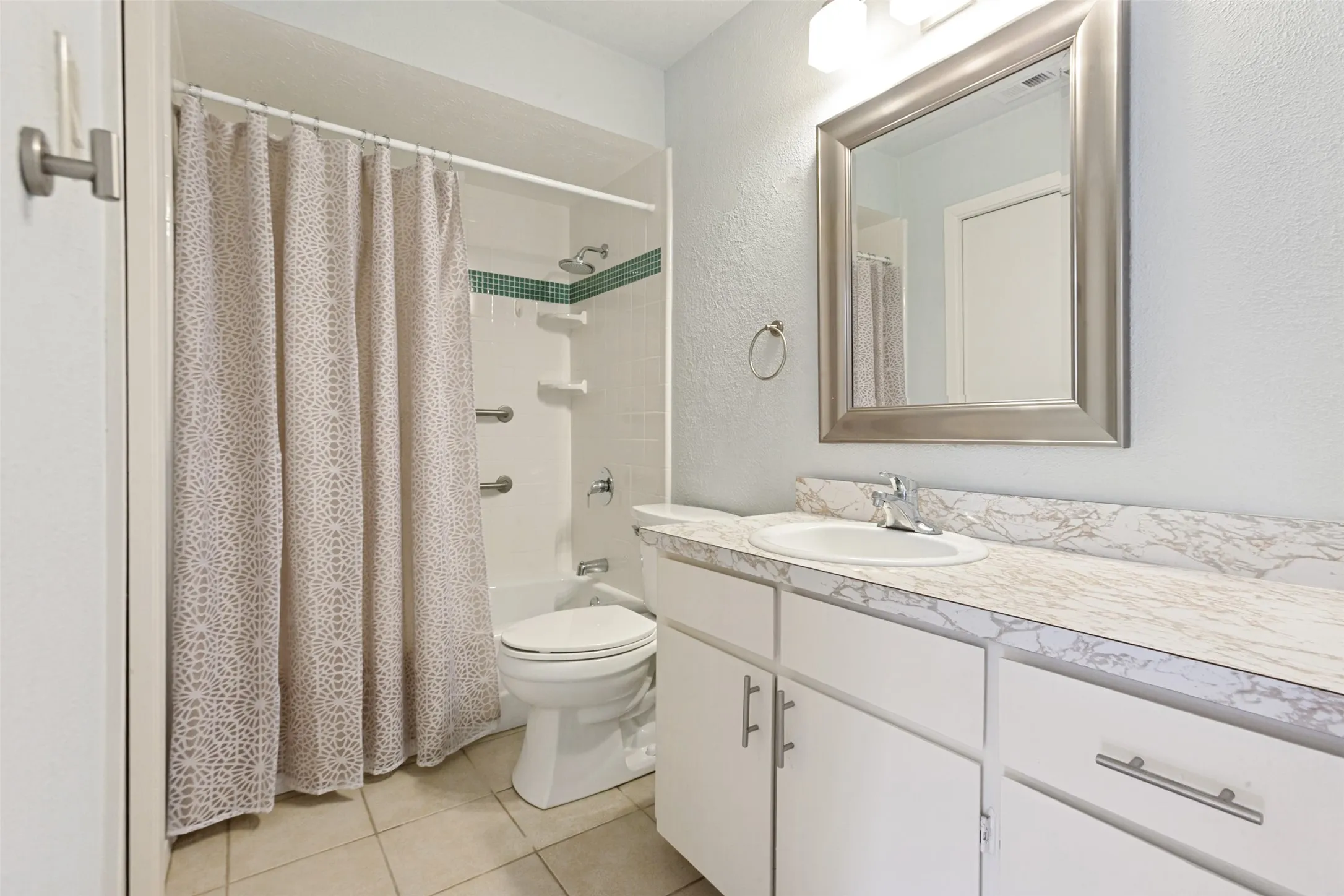 White vanity with a single basin sink, framed mirror, and chrome faucet