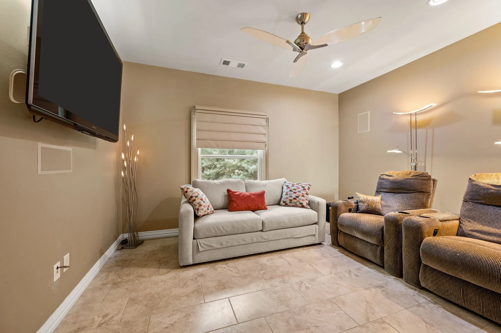 Tiled flooring, recessed ceiling lighting, ceiling fan, window with shade, mounted wall panel