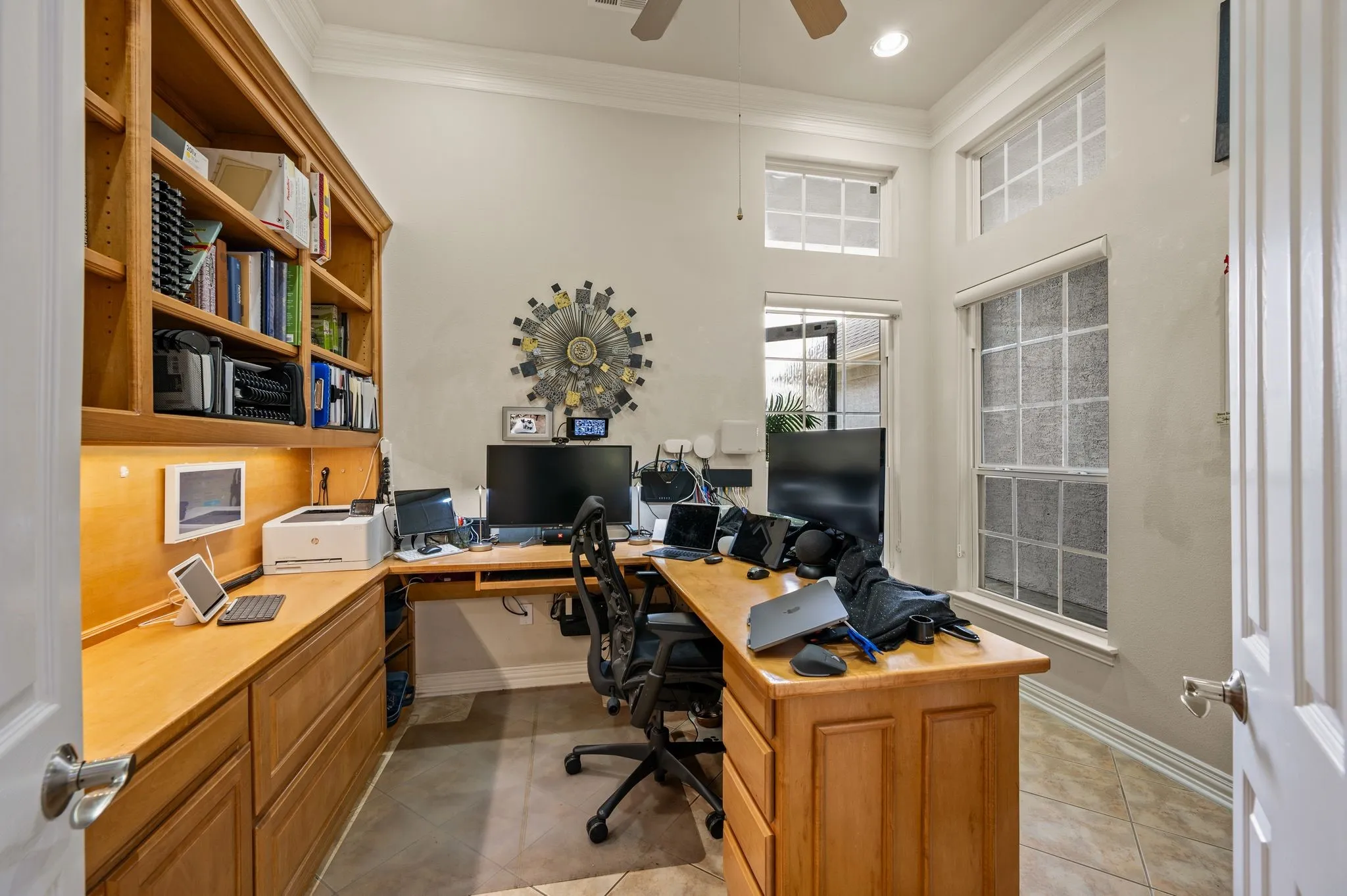 Built-in wood-finish cabinetry with integrated shelving and task lighting