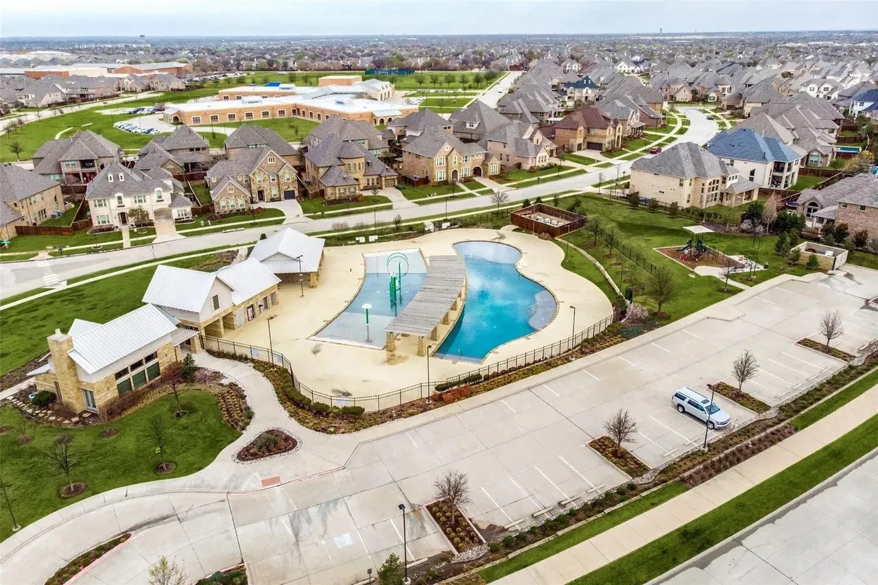 Community amenities featuring a swimming pool, shaded seating areas, and a dedicated parking lot