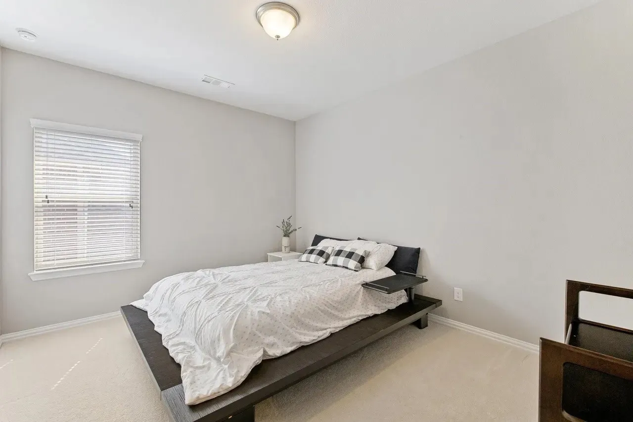Recessed window with blinds, ceiling-mounted light fixture, and light-toned wall paint