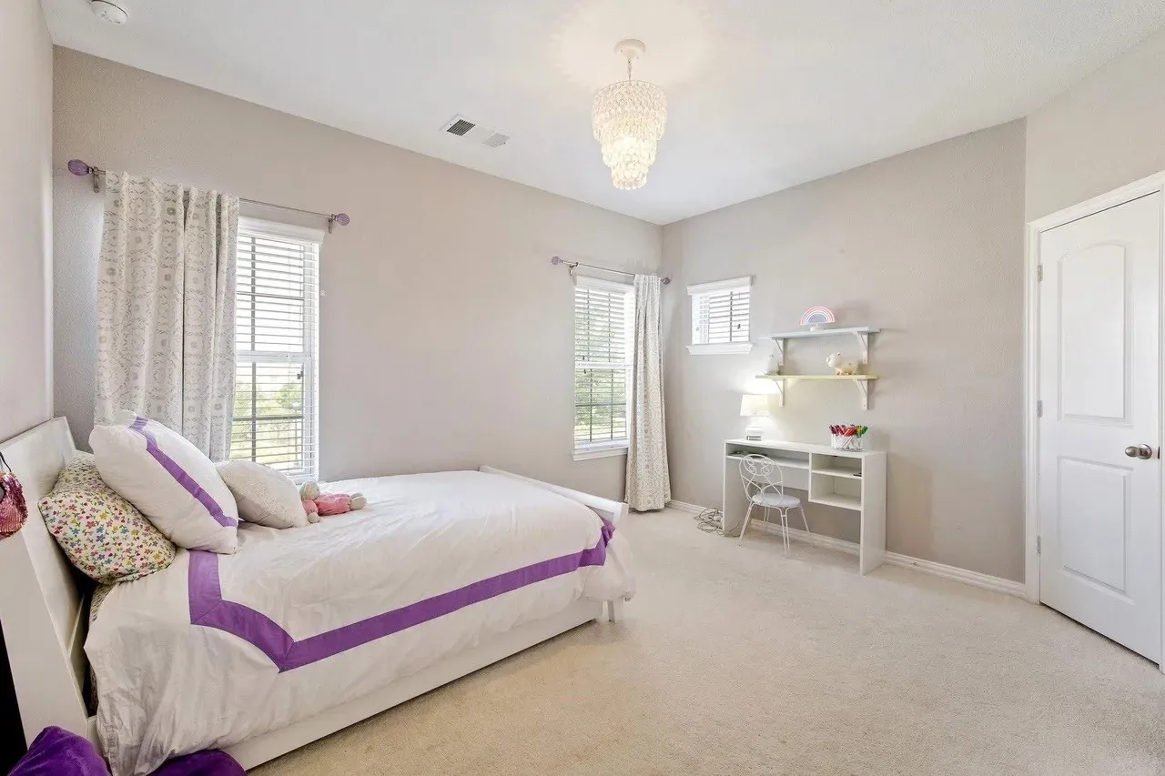 Recessed lighting, large window with blinds, additional window with blinds, built-in shelving, chandelier