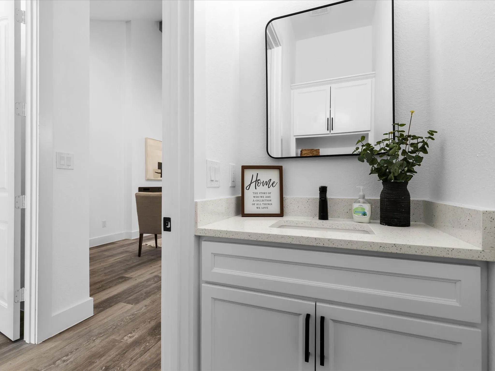 Built-in vanity with light-toned countertop and integrated sink