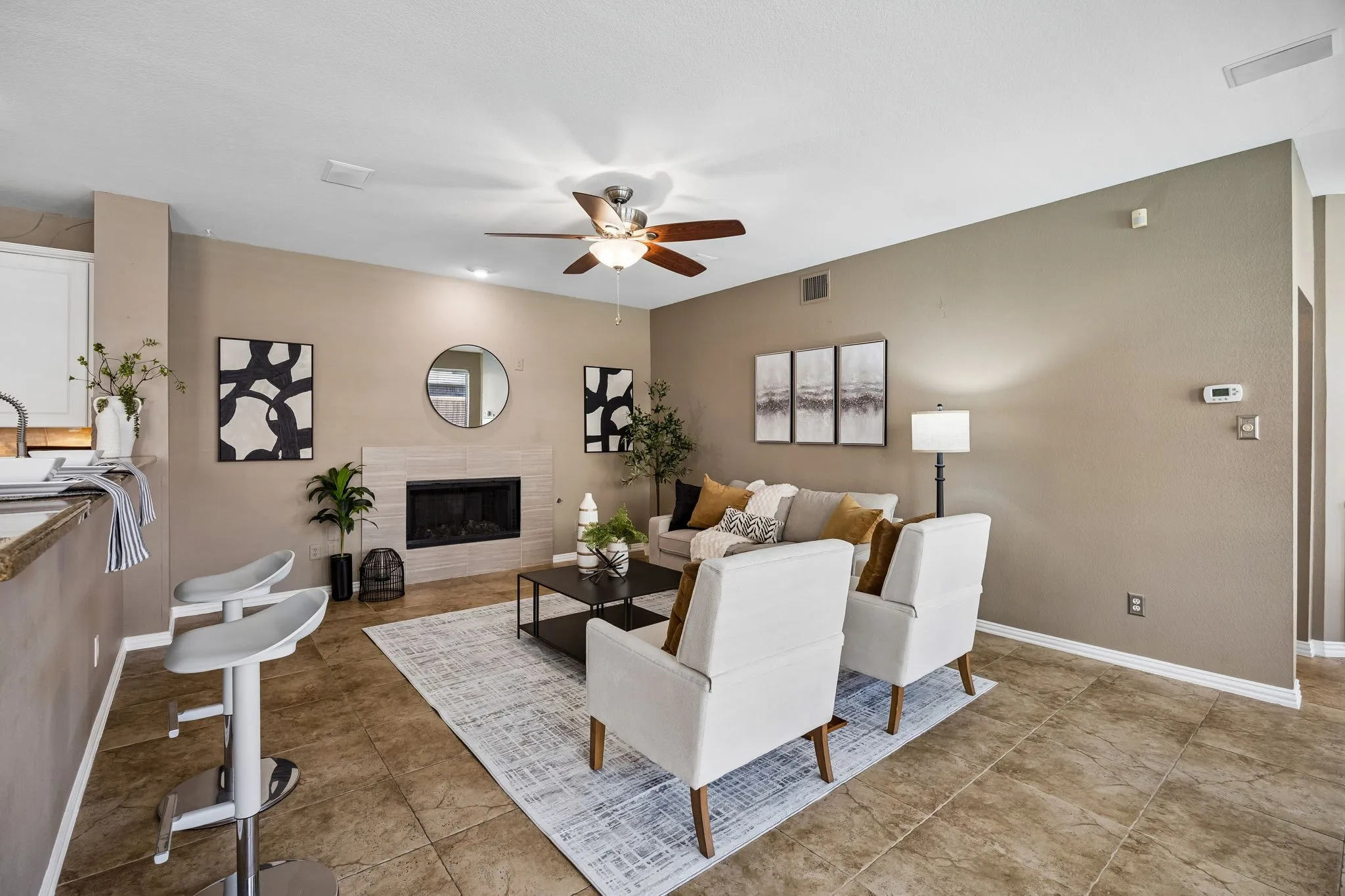 Spacious living area featuring tile flooring, a built-in fireplace, a ceiling fan, and recessed lighting