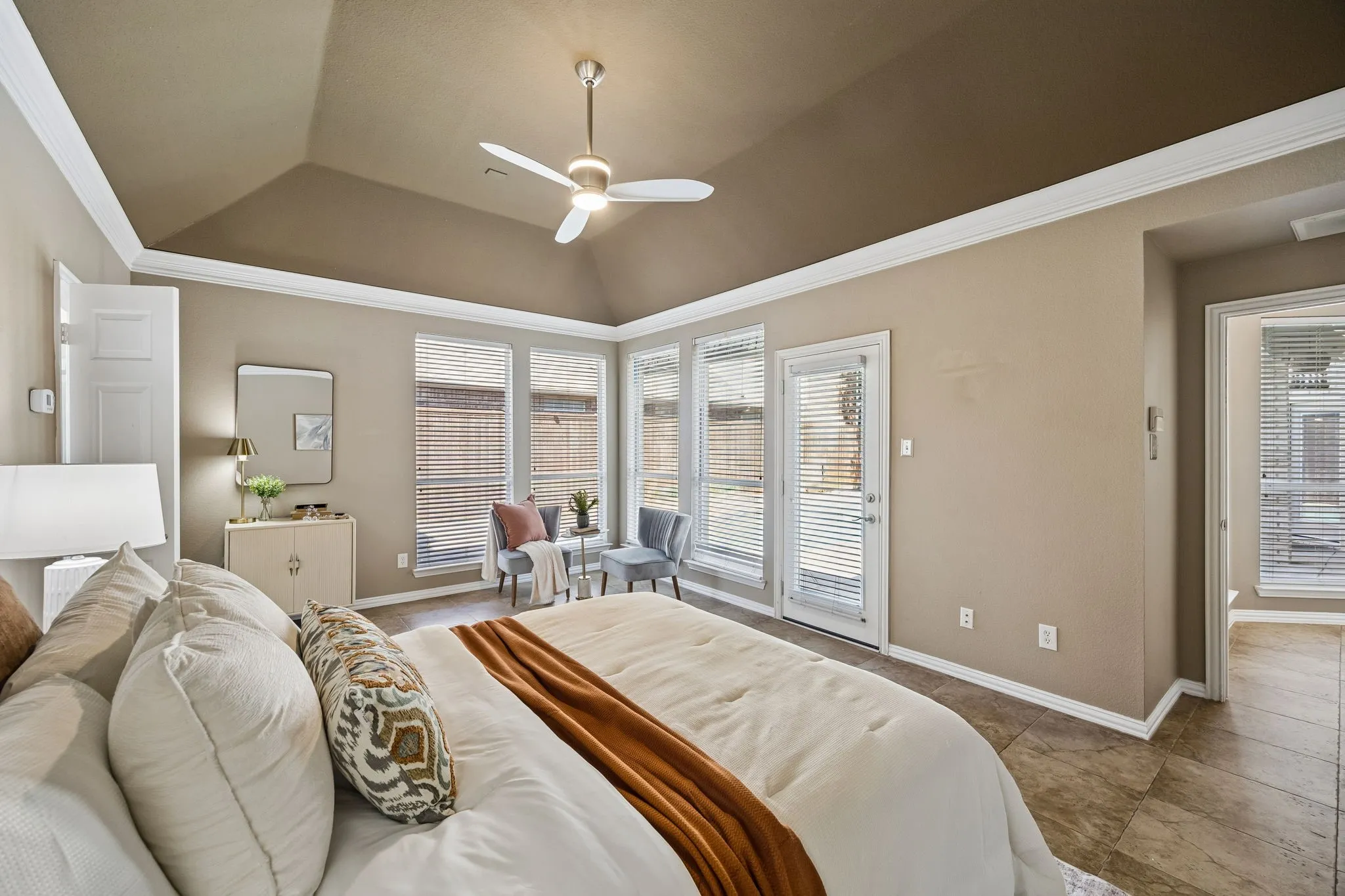 Vaulted ceiling with crown molding, ceiling fan, and recessed lighting