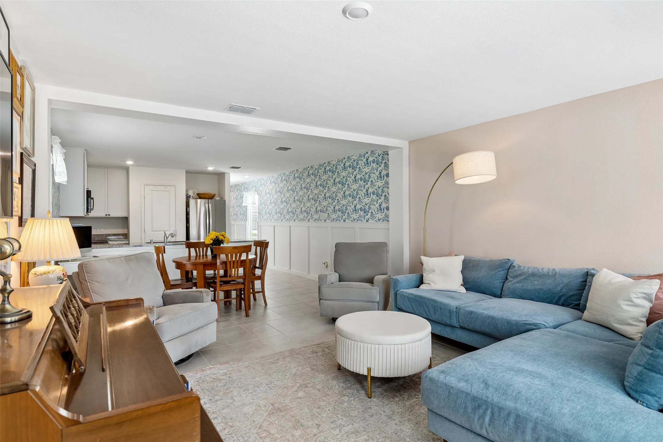 Open-concept living area with tile flooring and recessed lighting