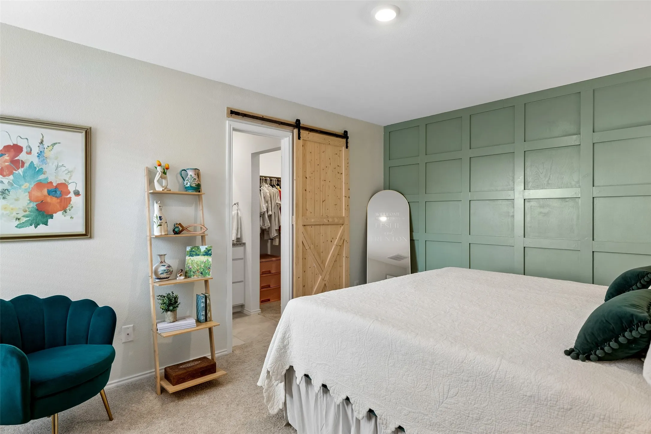 Green accent wall with wainscoting, recessed ceiling lighting, wood-finish sliding barn door, and carpeted flooring
