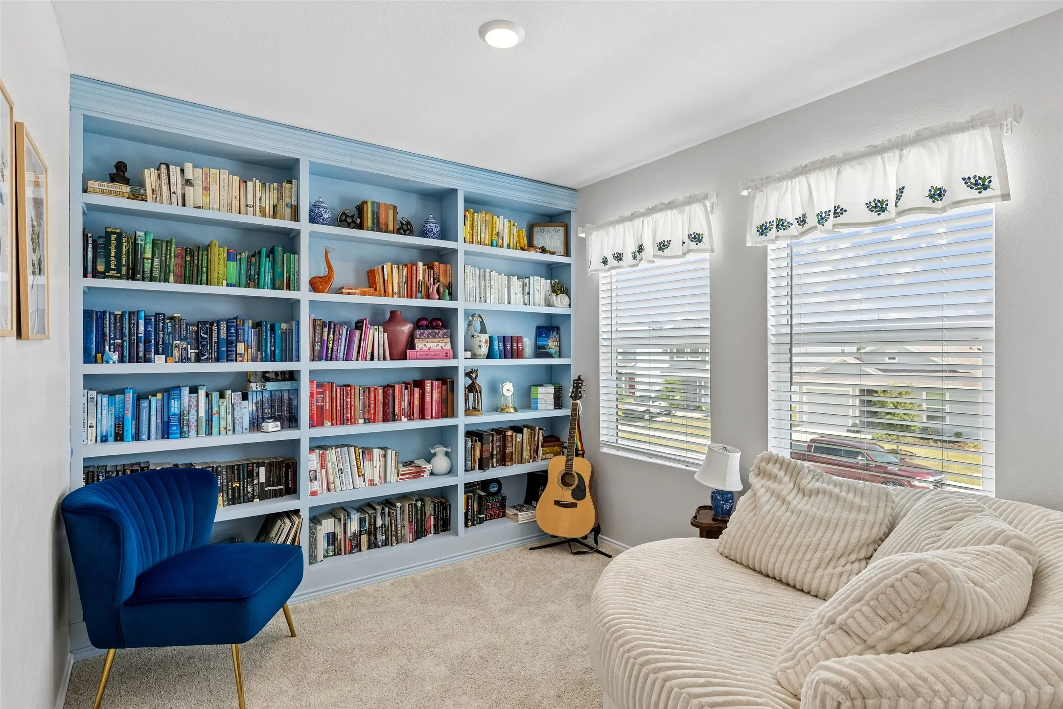 Built-in shelving, recessed lighting, wall-to-wall carpeting, and multiple windows with blinds