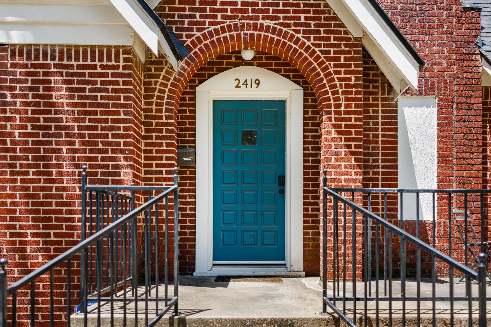 Red brick exterior with an arched entry