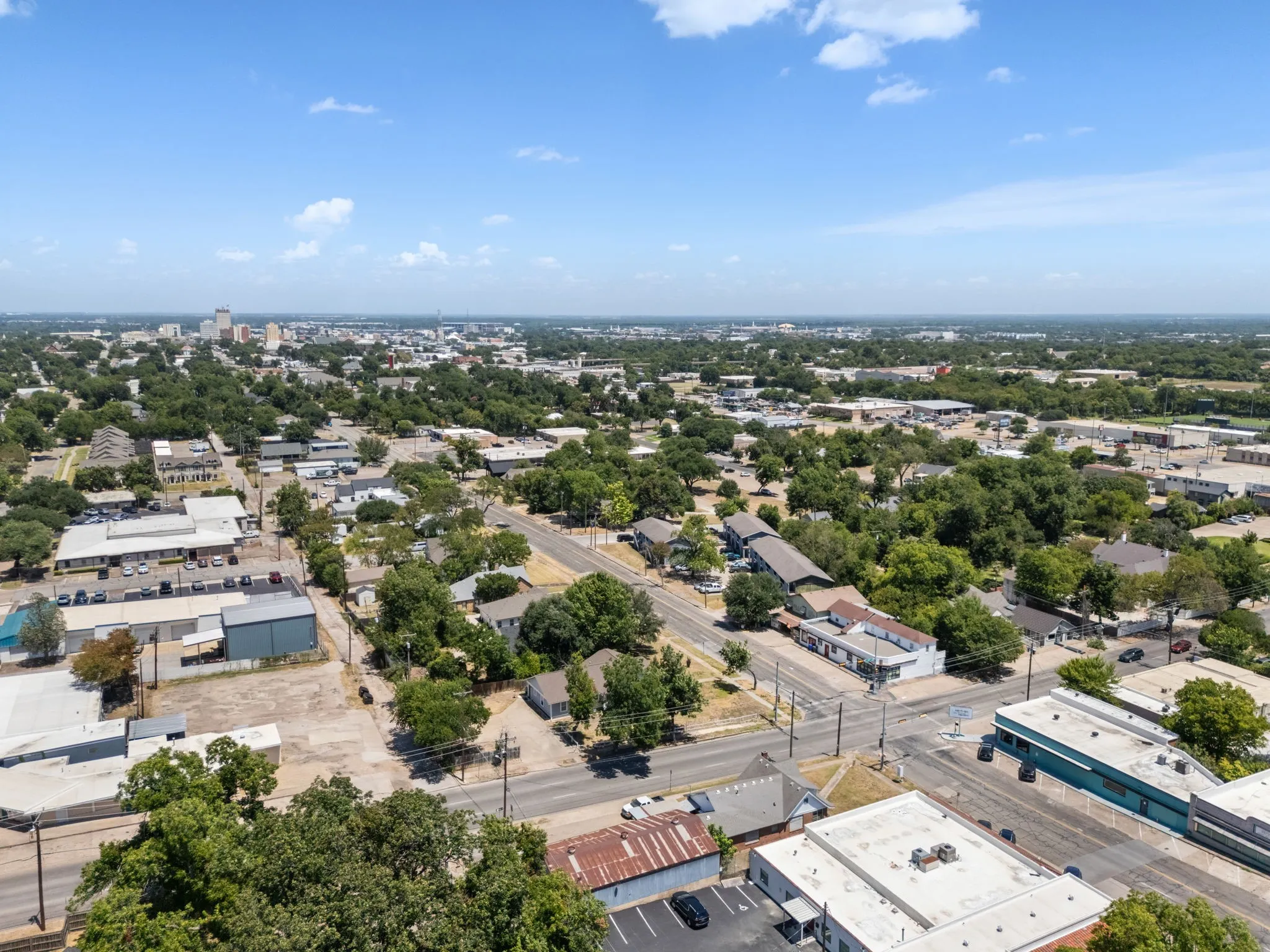 Aerial perspective of a developed urban area with a distant city skyline
