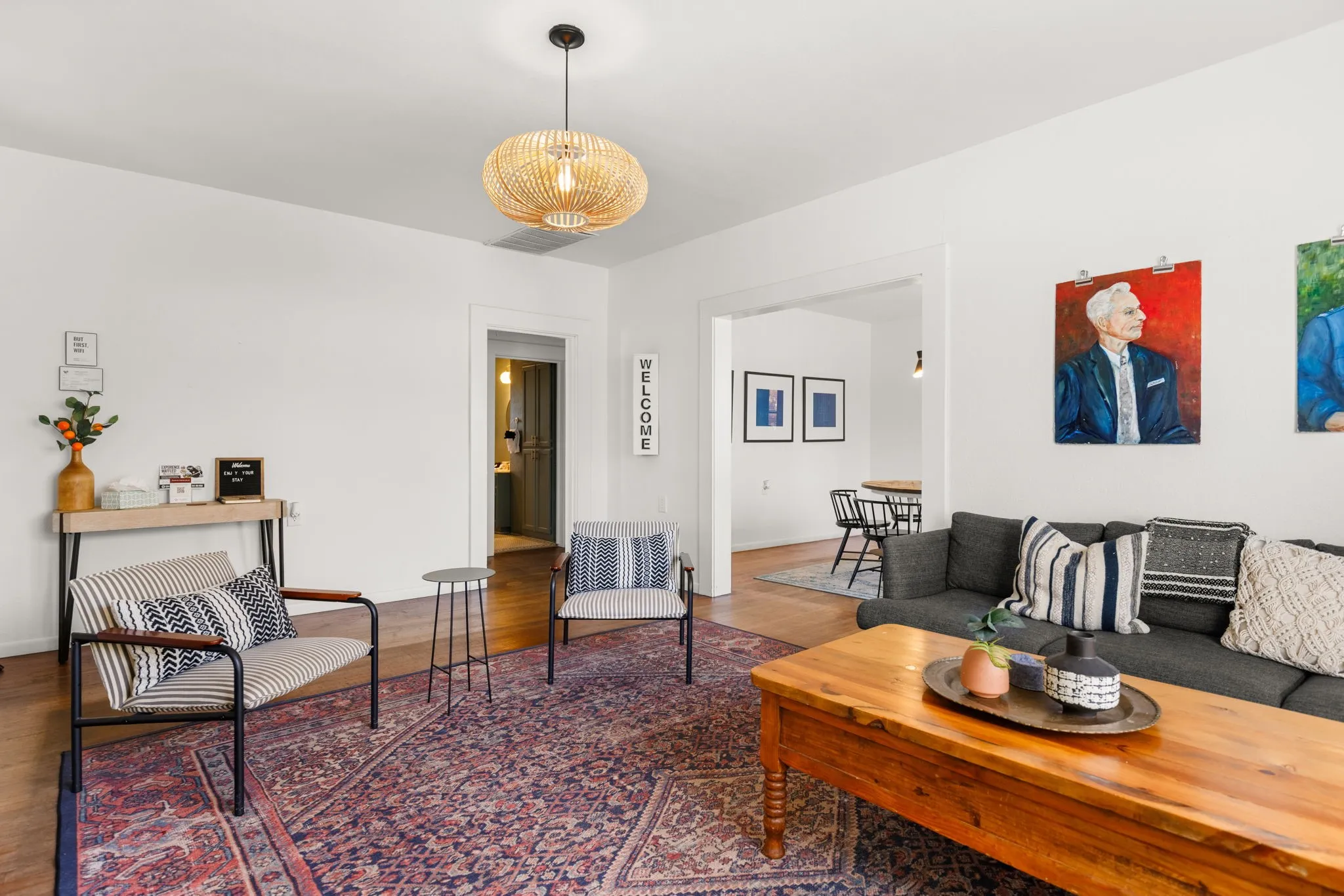 Hardwood flooring throughout, with a woven pendant light fixture