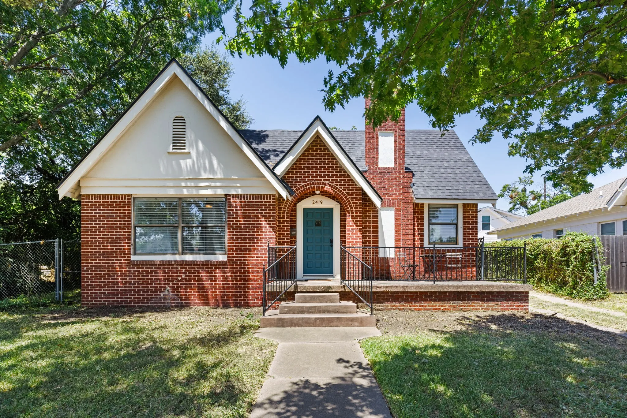 Brick exterior with white gable accents and a dark roof