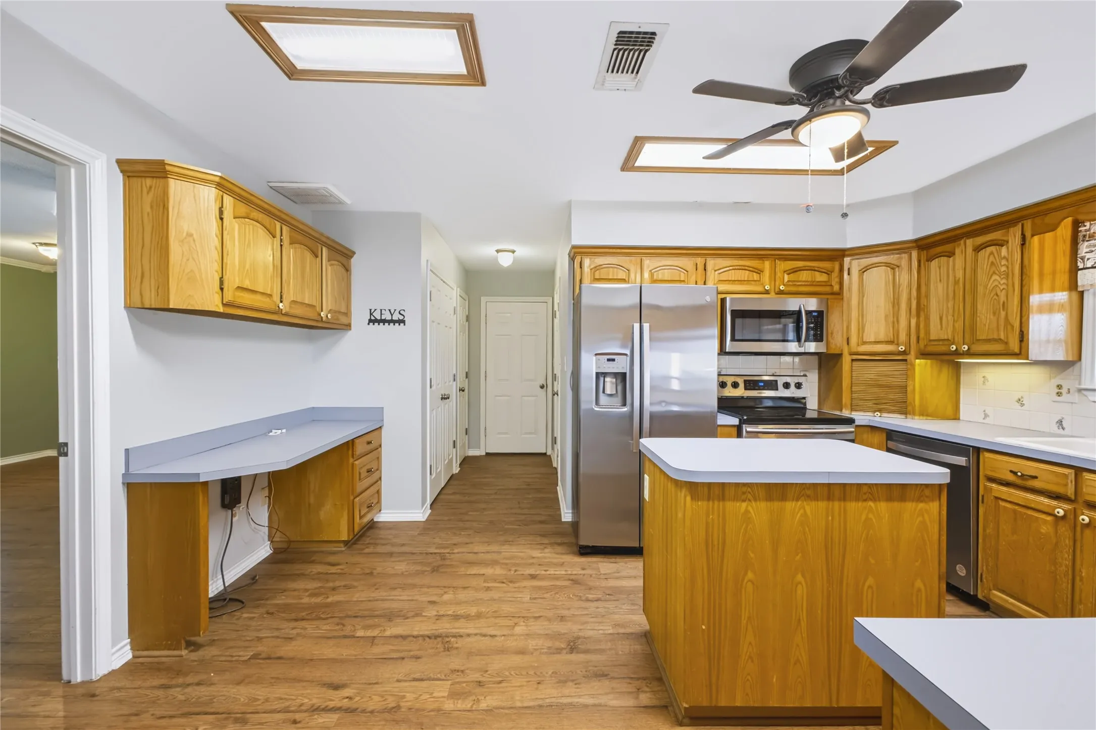 Built-in desk provides an office area in kitchen.
