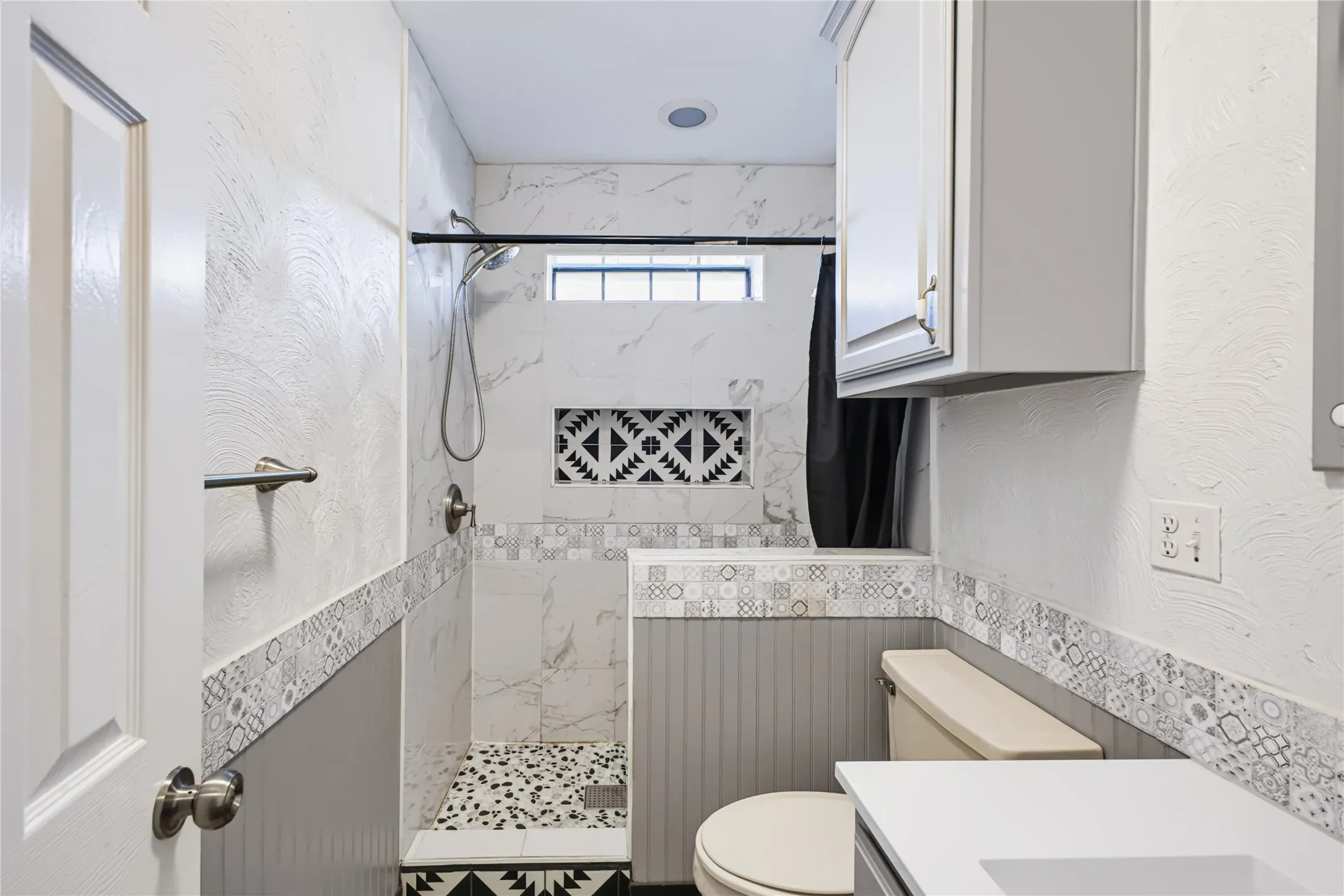 Updated guest bathroom with new tile and vanity.