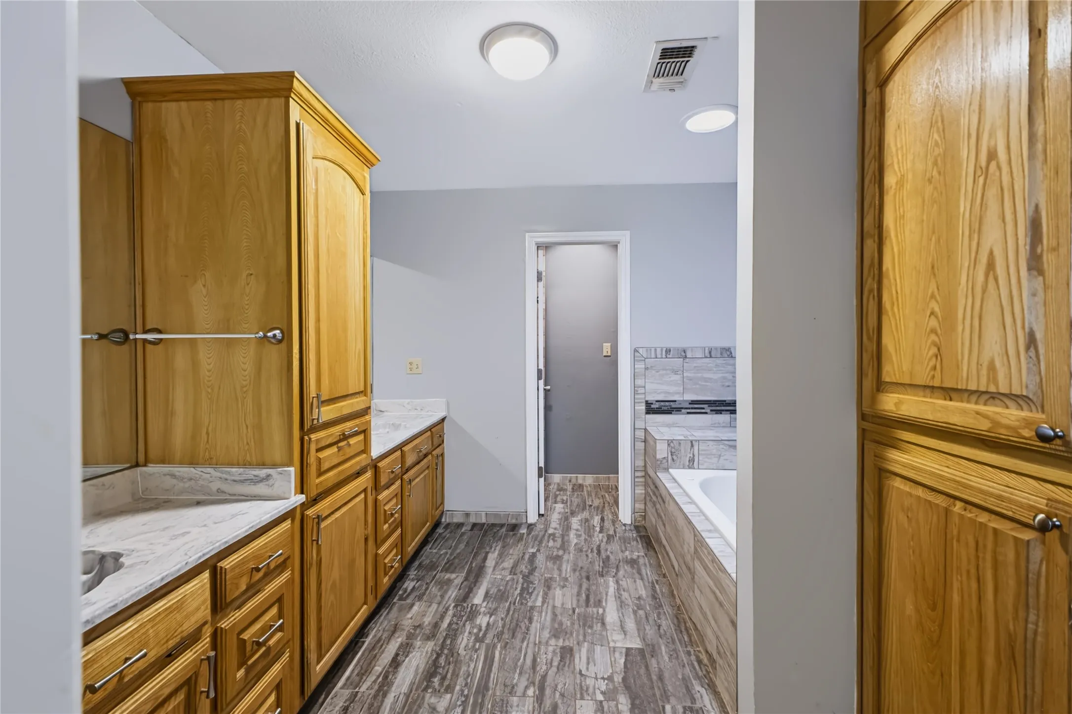 Primary bathroom has split sinks & lots of storage!