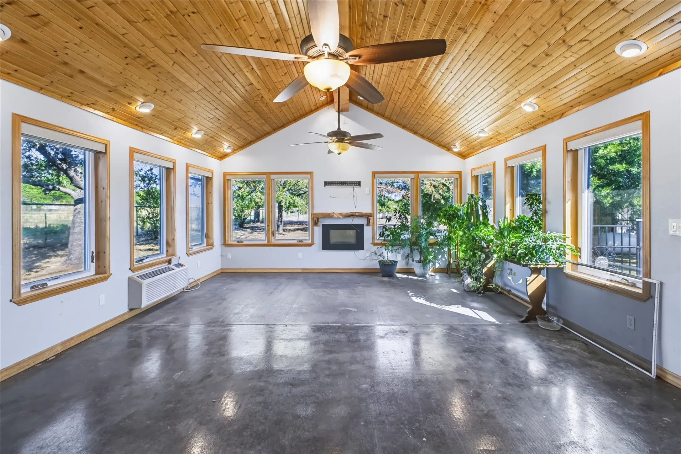 Great sunroom with mini-split AC and decorative fireplace