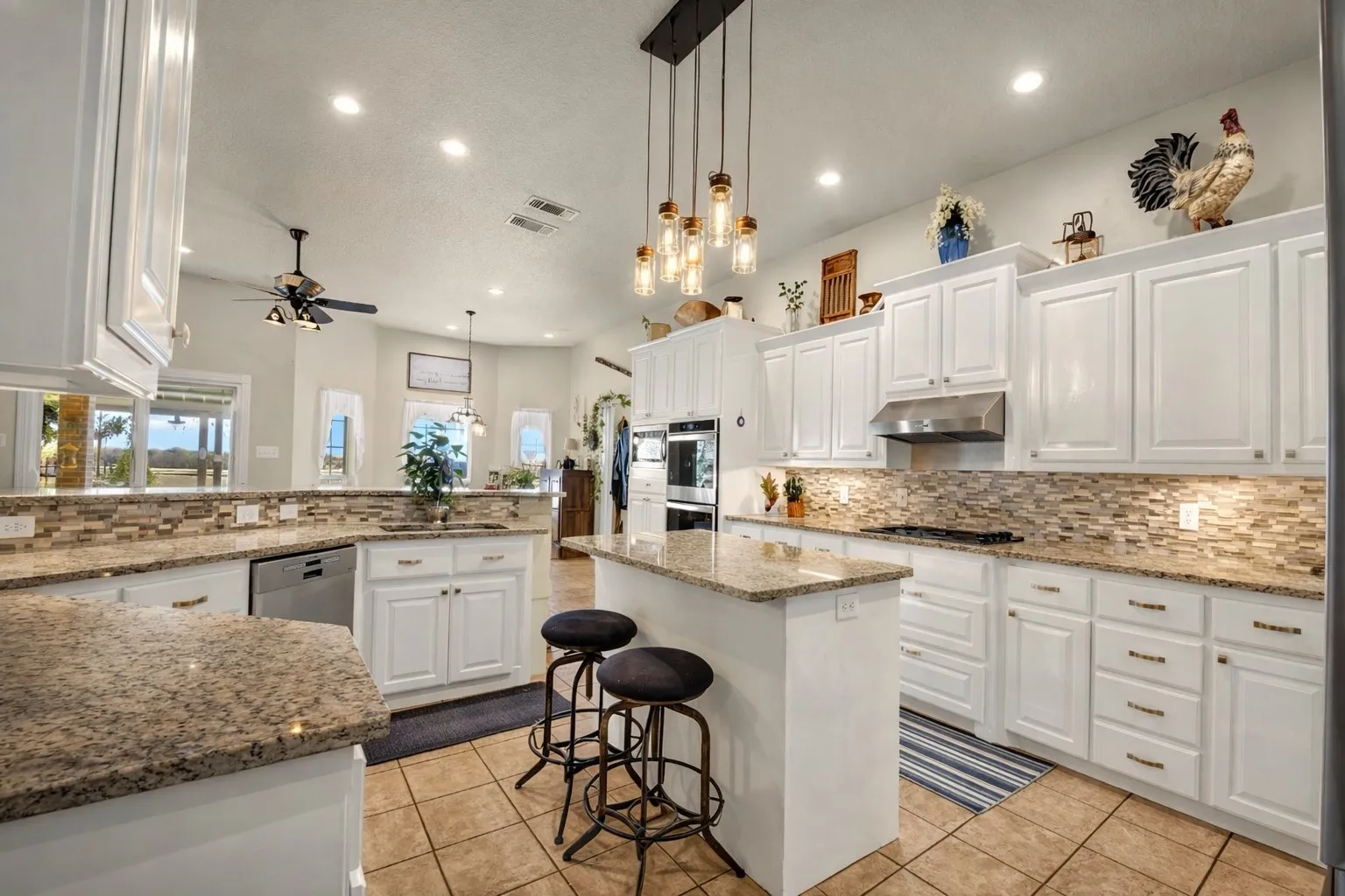 Kitchen featuring white cabinetry, granite countertops, a built-in oven, and a tiled backsplash