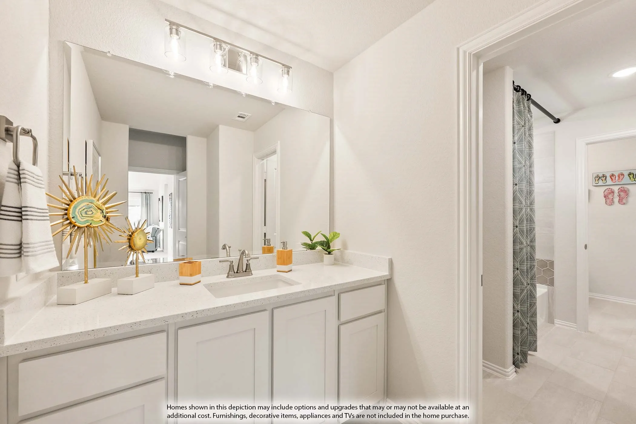 Spacious vanity with extensive countertop space, integrated sink, large wall-mounted mirror, and overhead track lighting
