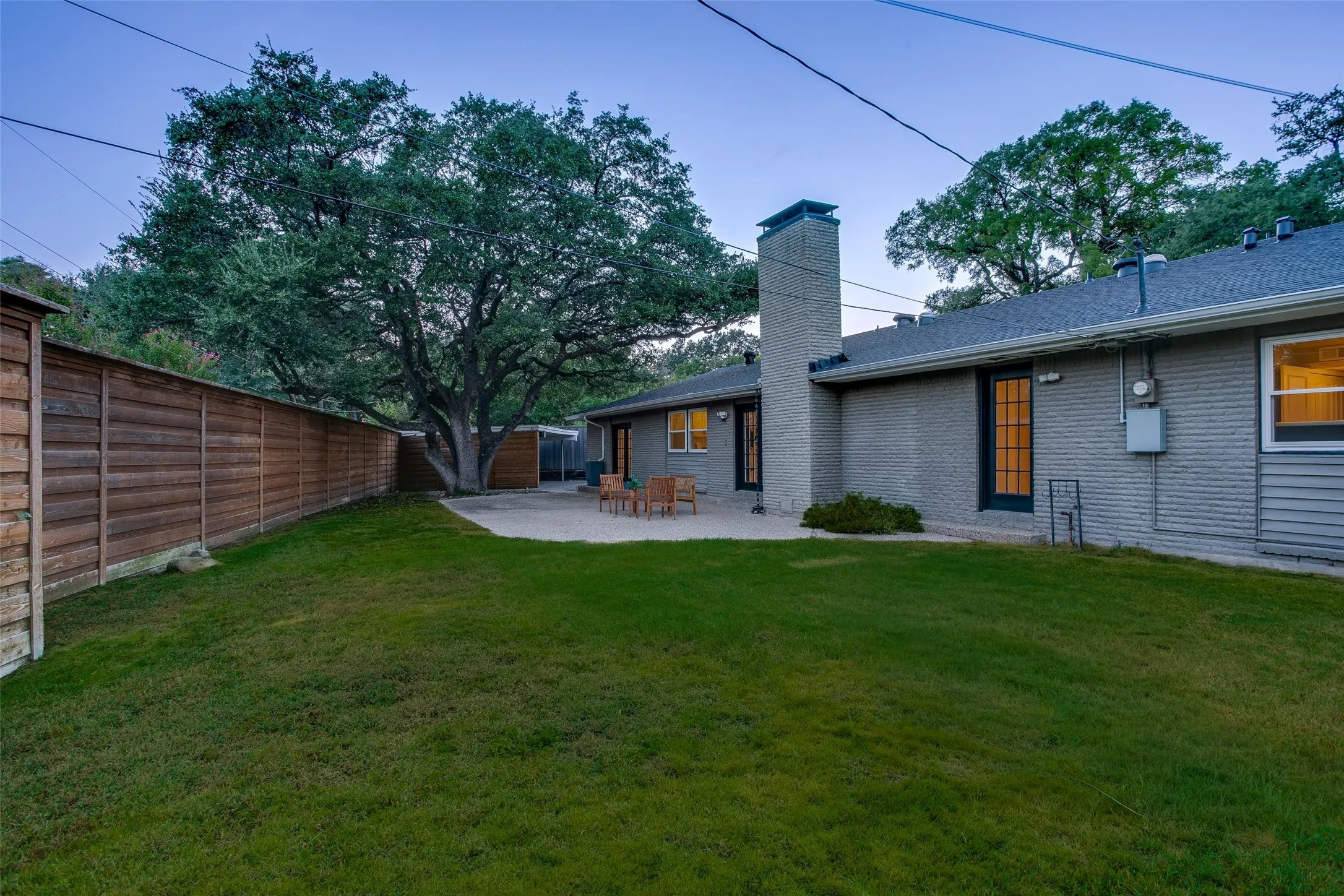 Private backyard offers huge lawn with Rachio sprinkler system, patio space and mature trees on nearly one-third of an acre.