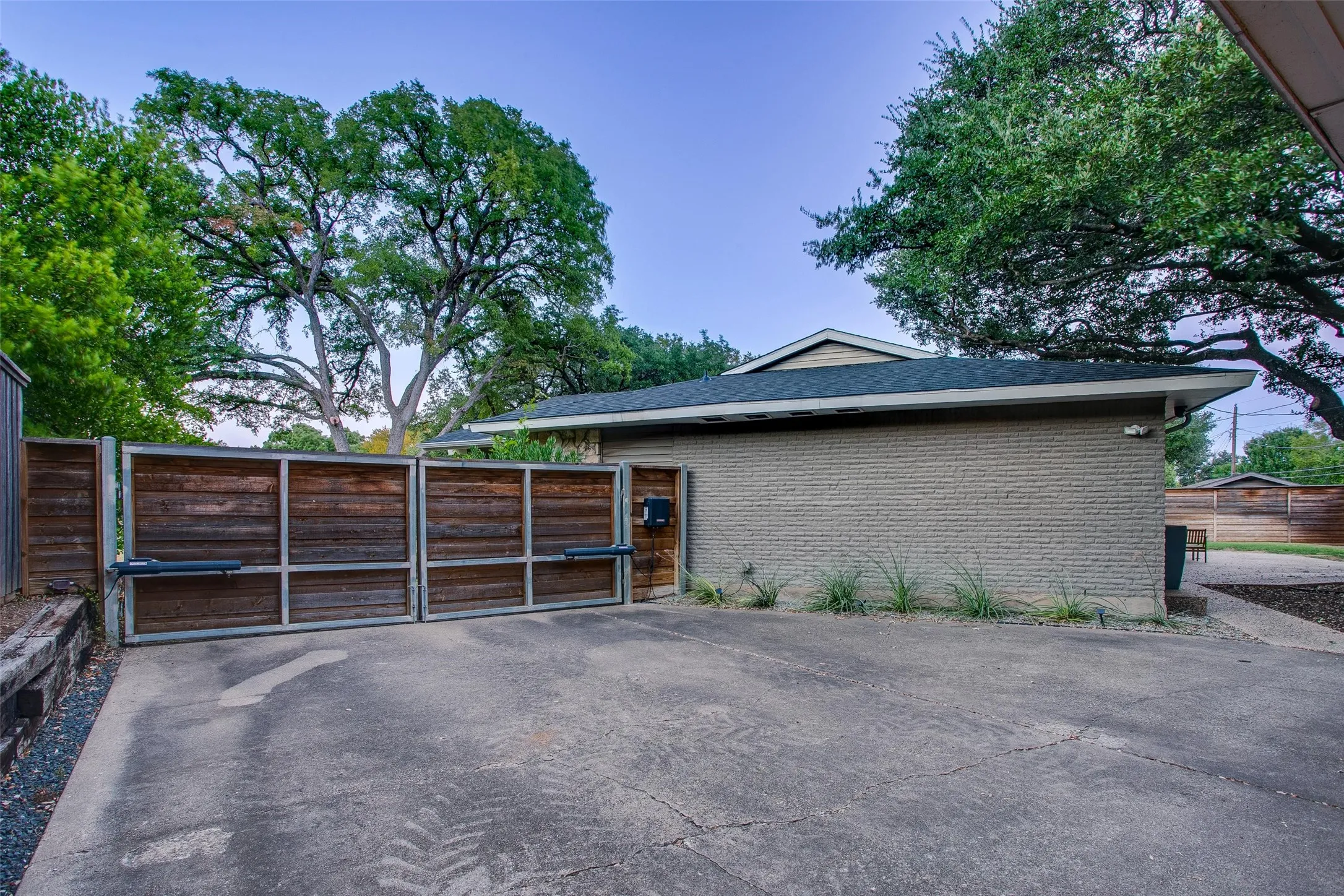 Motorized driveway gate adds privacy to the rear parking and backyard.
