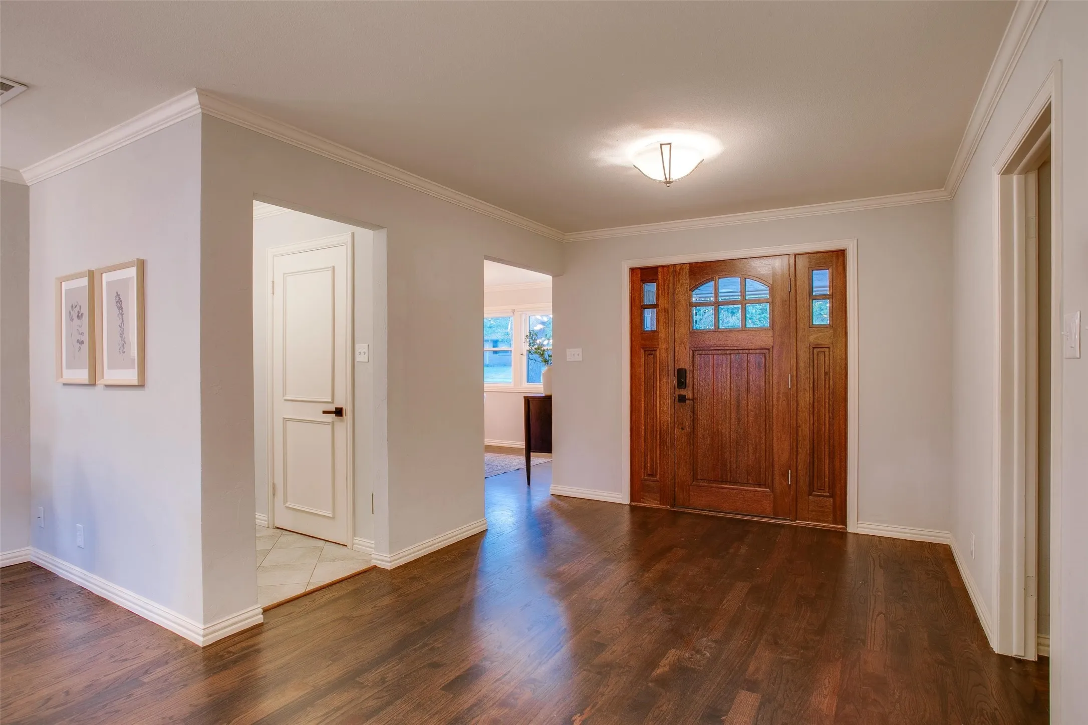 Spacious entry introduces the home's warm hardwood flooring and open, light-filled layout.
