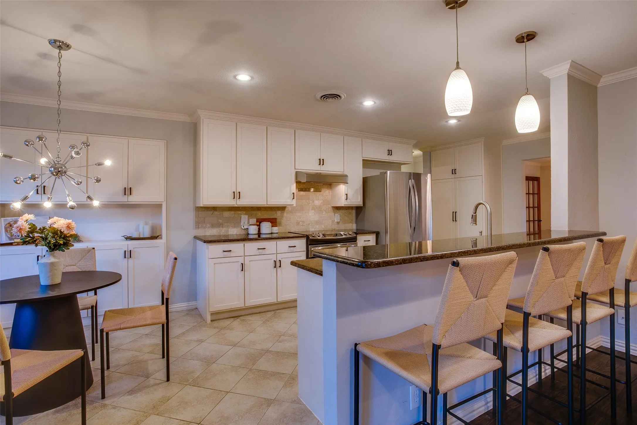 Custom Kitchen with expansive barstool counter, generous cabinetry and stainless appliances.