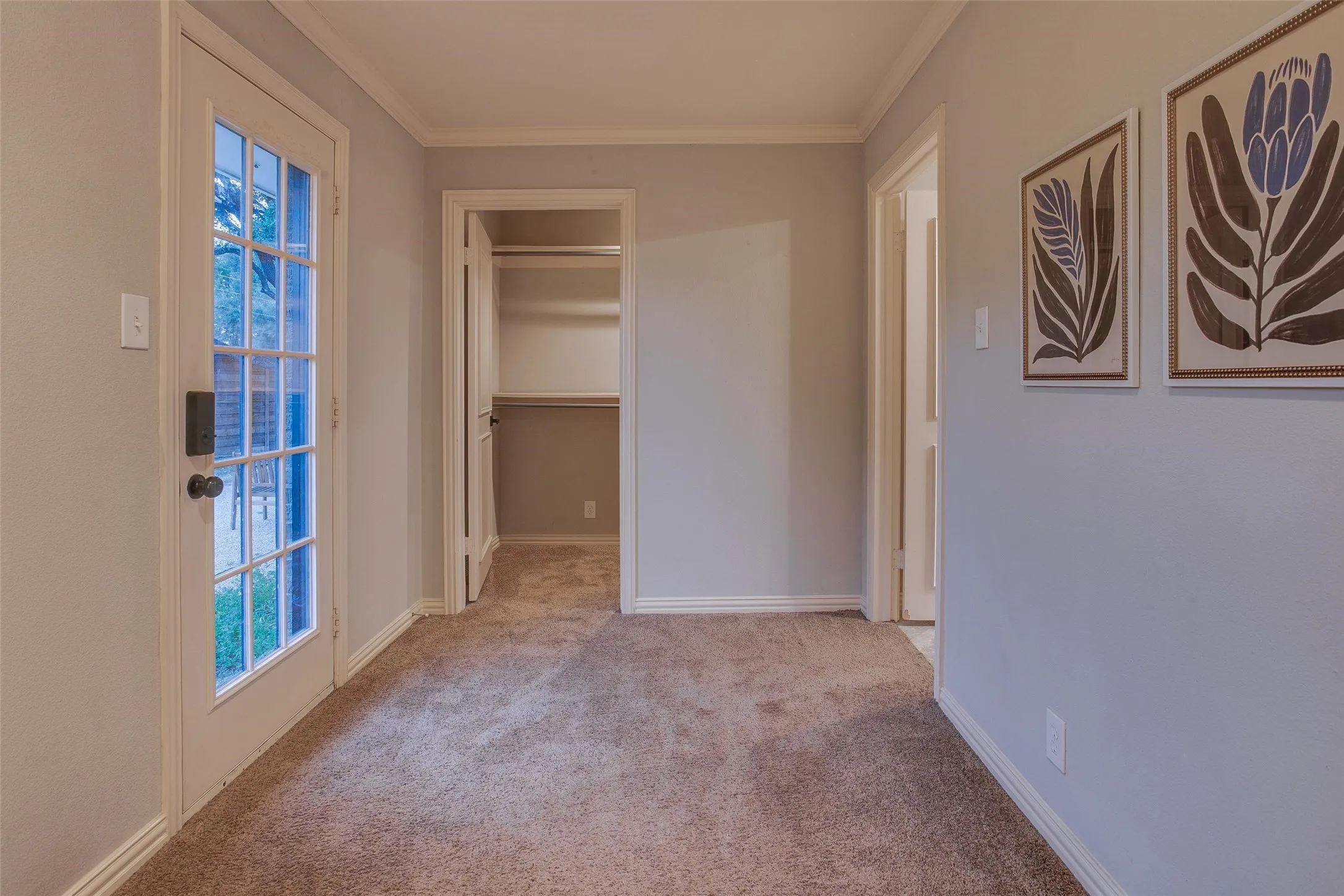 Versatile space between the Primary Bedroom and one of two walk-in closets...ideal for a desk, dresser or sitting area.