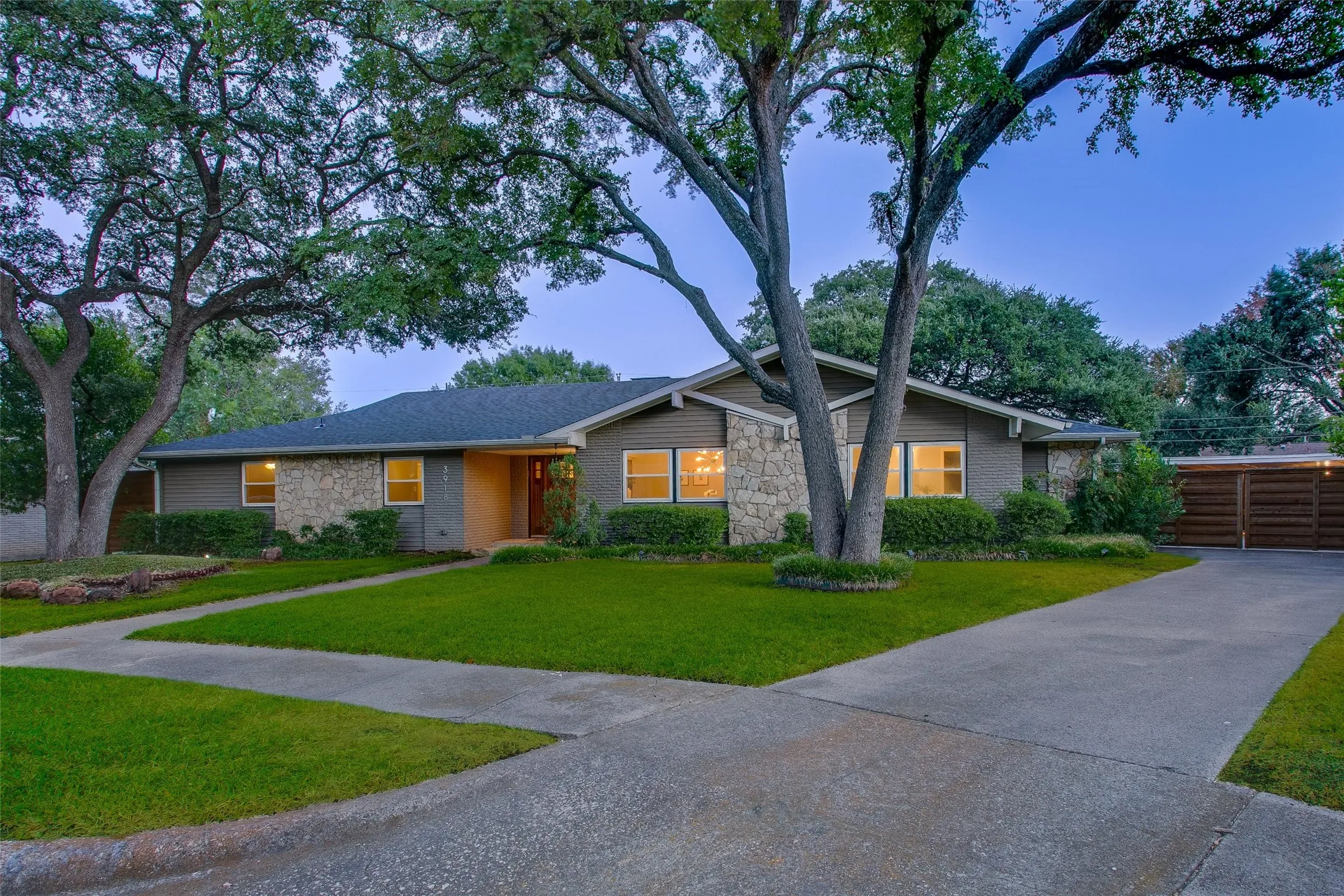 Nearly one-third-acre setting with mature trees and a motorized gated driveway.

