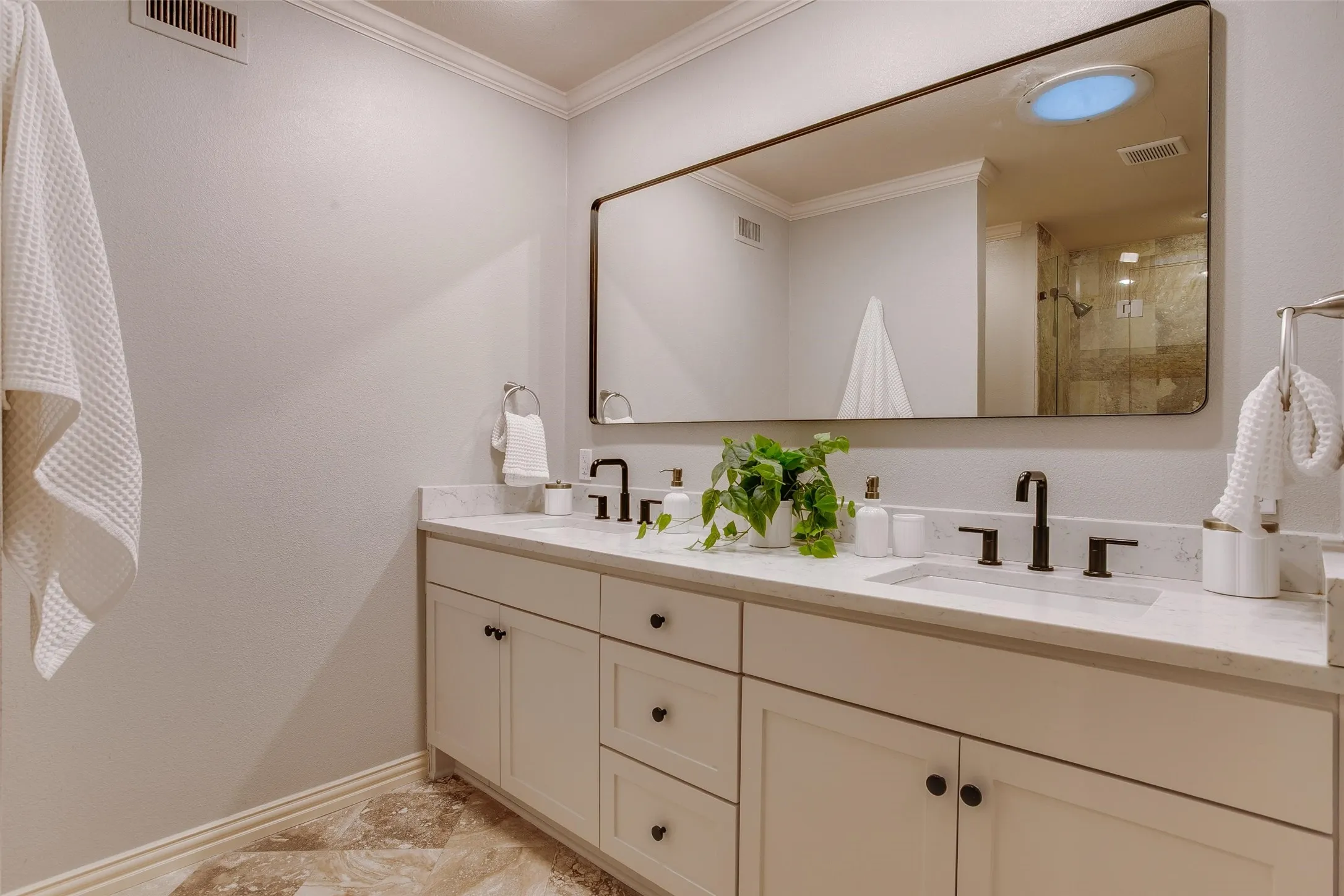 Renovated Primary Bath with long dual-sink vanity and generous storage.