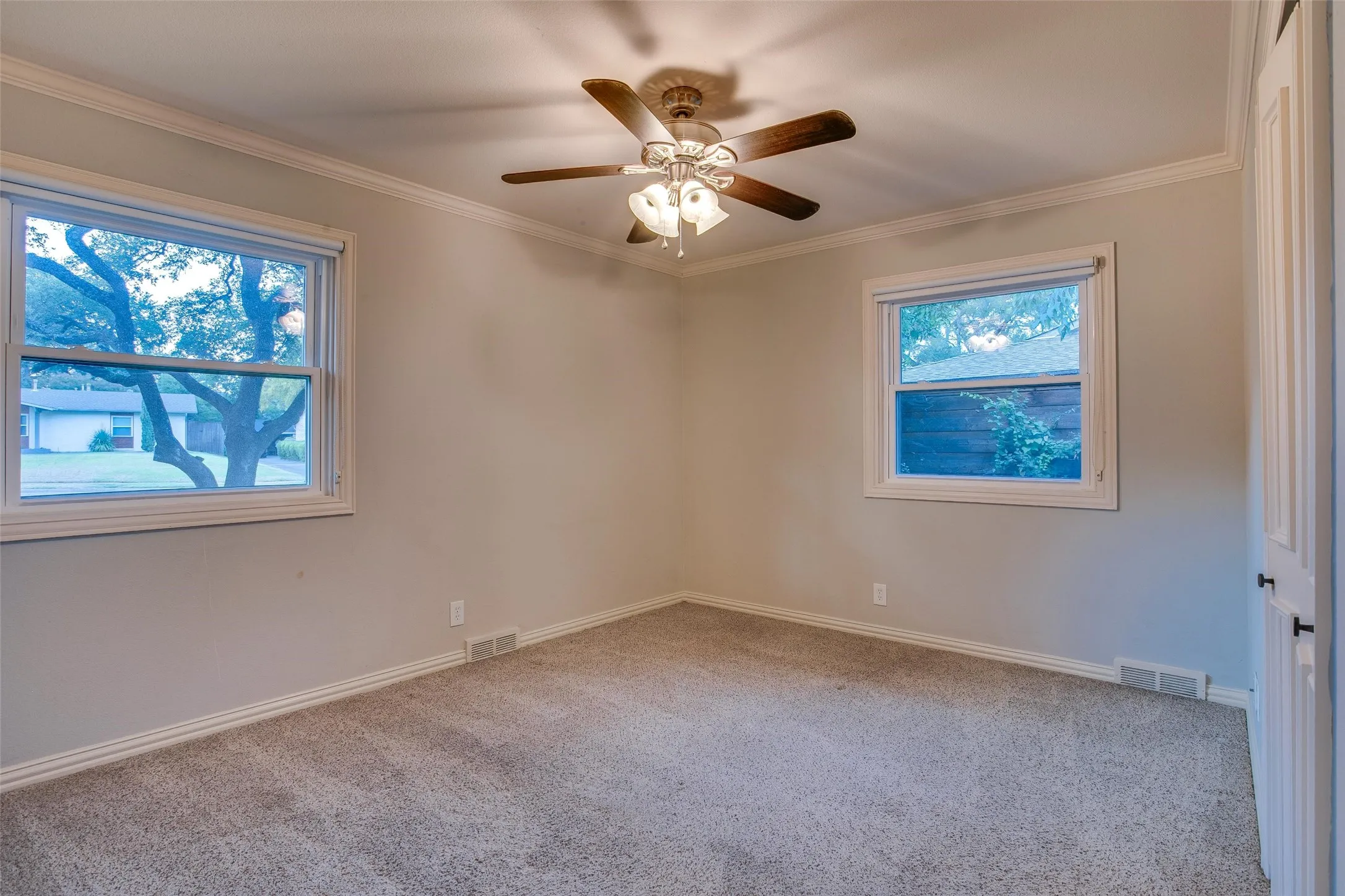 Bedroom 3 with two windows bringing in abundant natural light.

