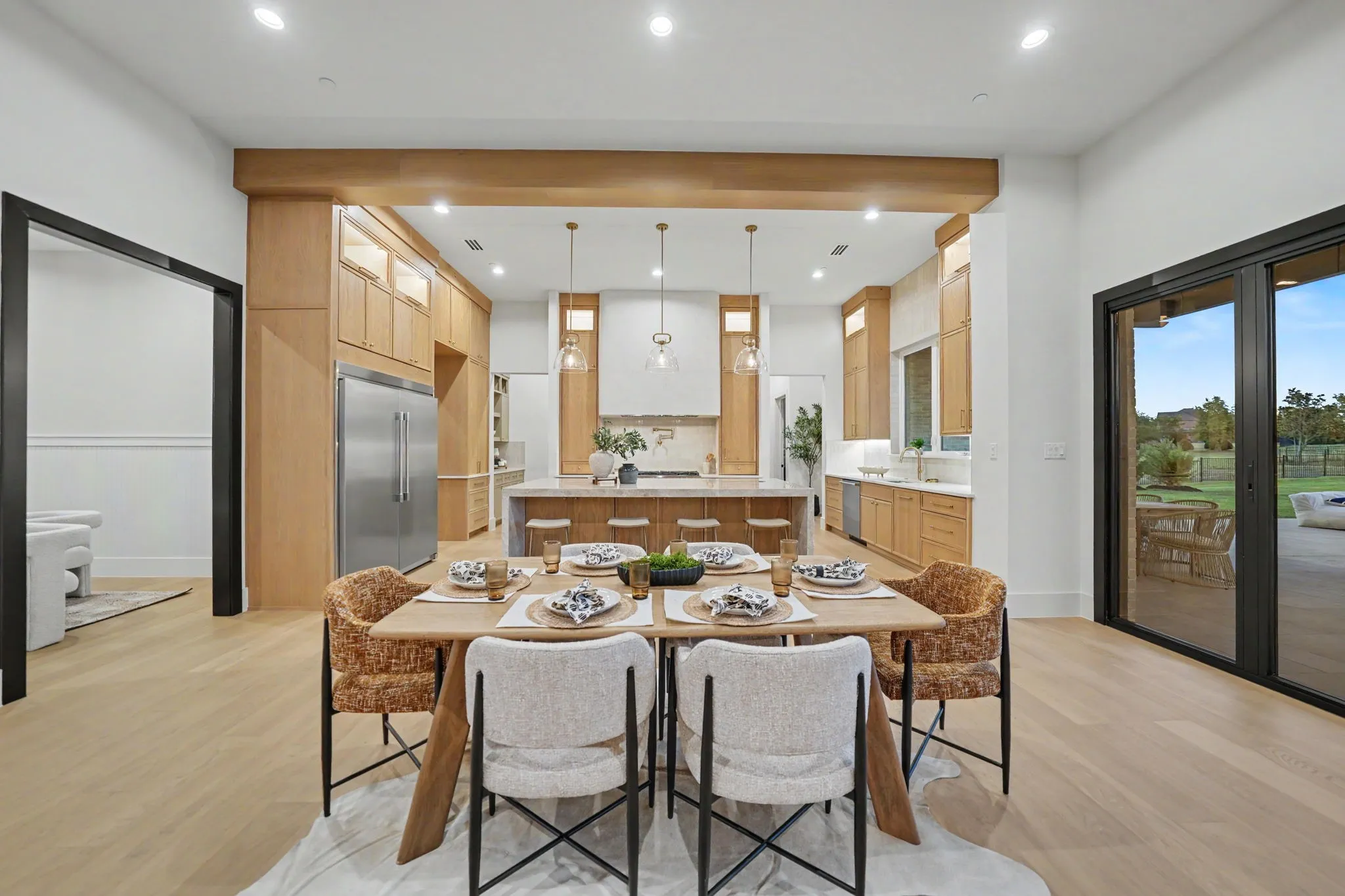 Spacious interior featuring light wood-finish flooring and recessed lighting