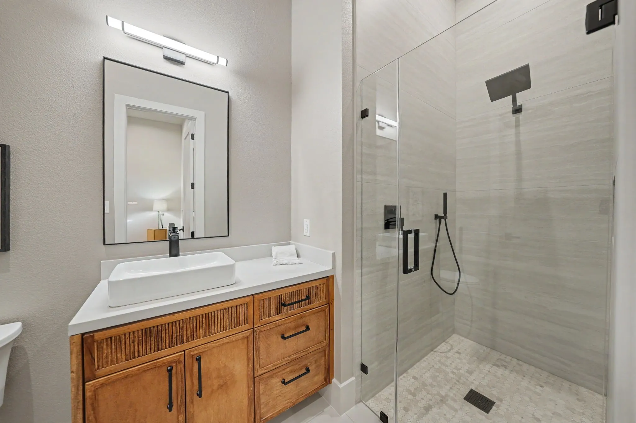 Custom vanity with a rectangular vessel sink, matte black faucet, and white countertop